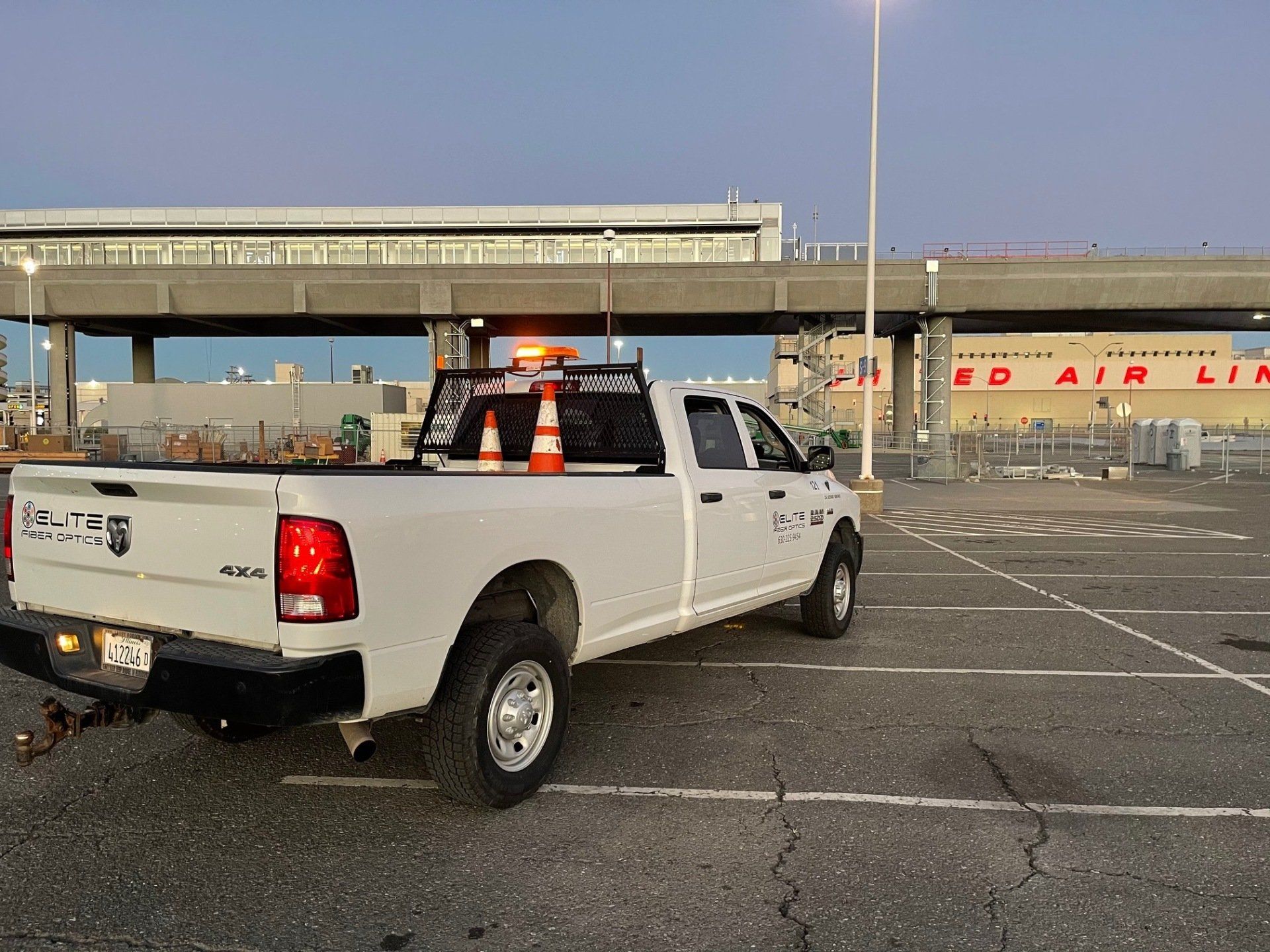 A white pickup truck is parked in a parking lot