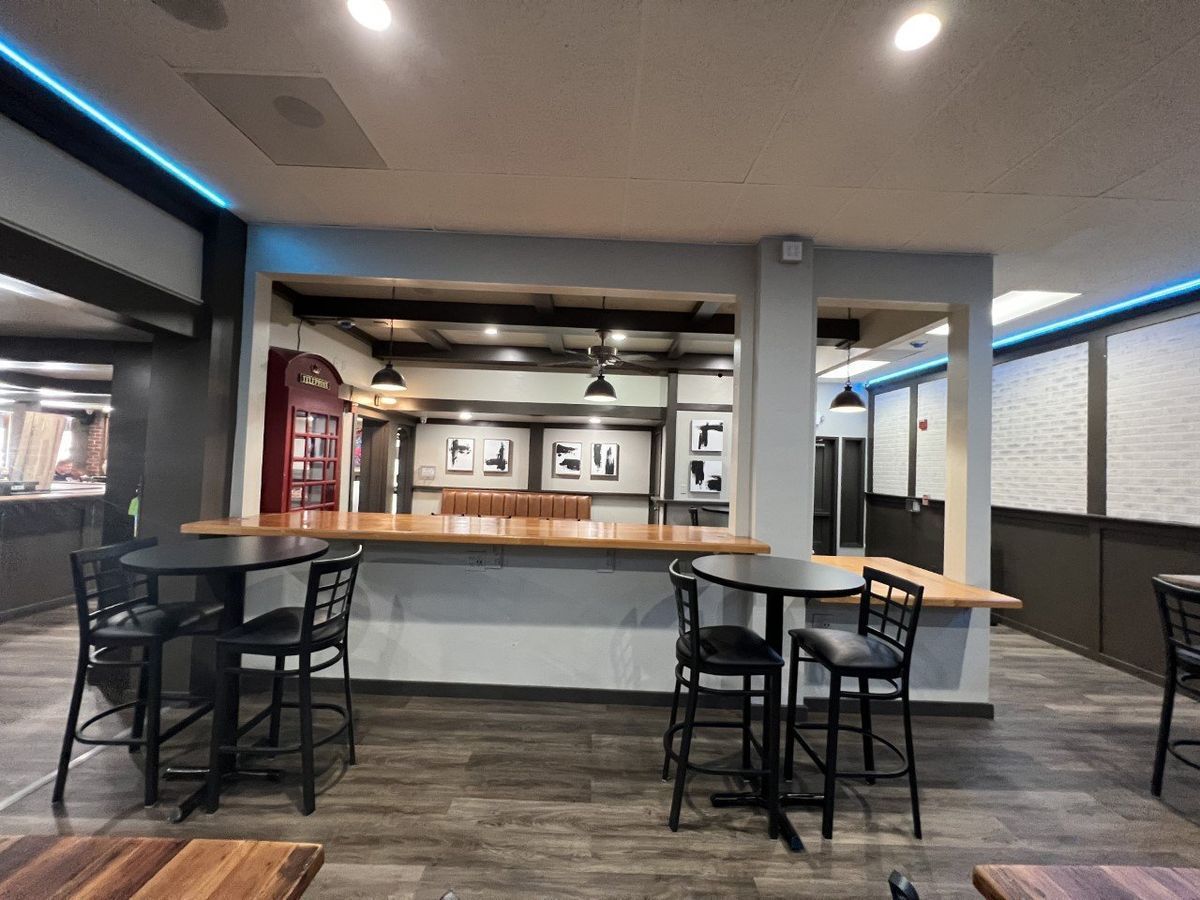 A restaurant with tables and chairs and a bar