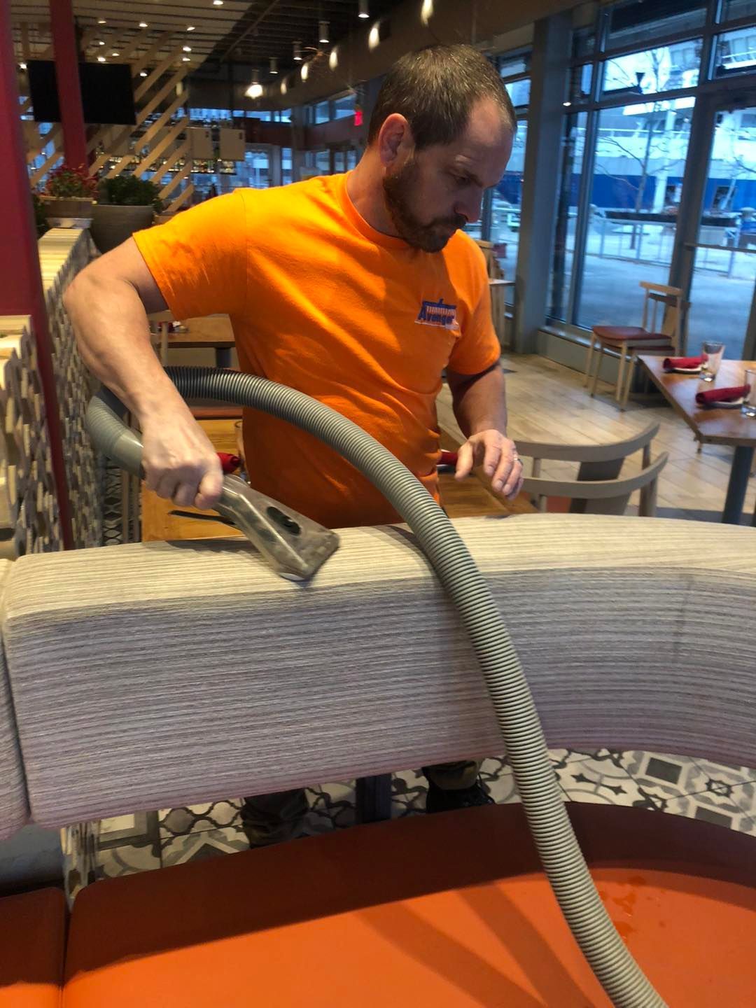 Man cleaning a couch in a restaurant near me in Cleveland, OH