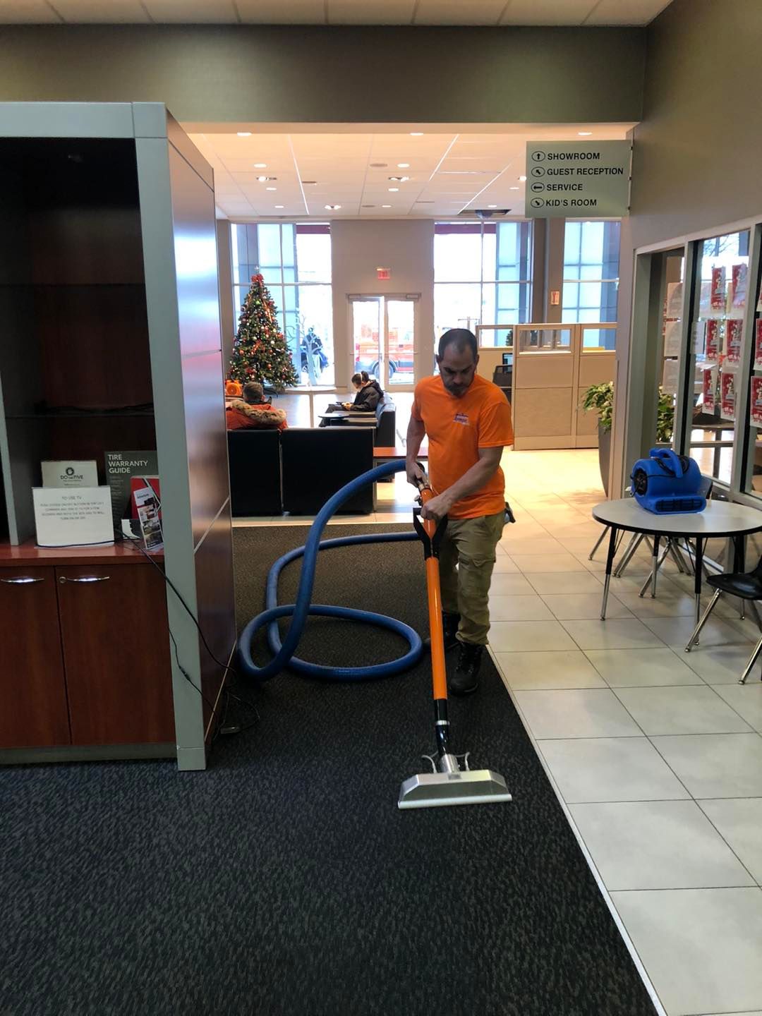 Cleaning technician vacuuming a carpet in a residential Cleveland property.