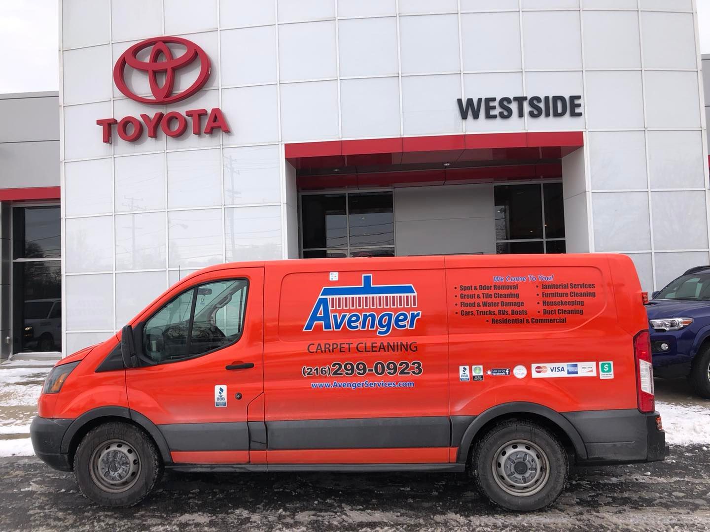 Red van parked in front of a Toyota dealership in the Cleveland area.