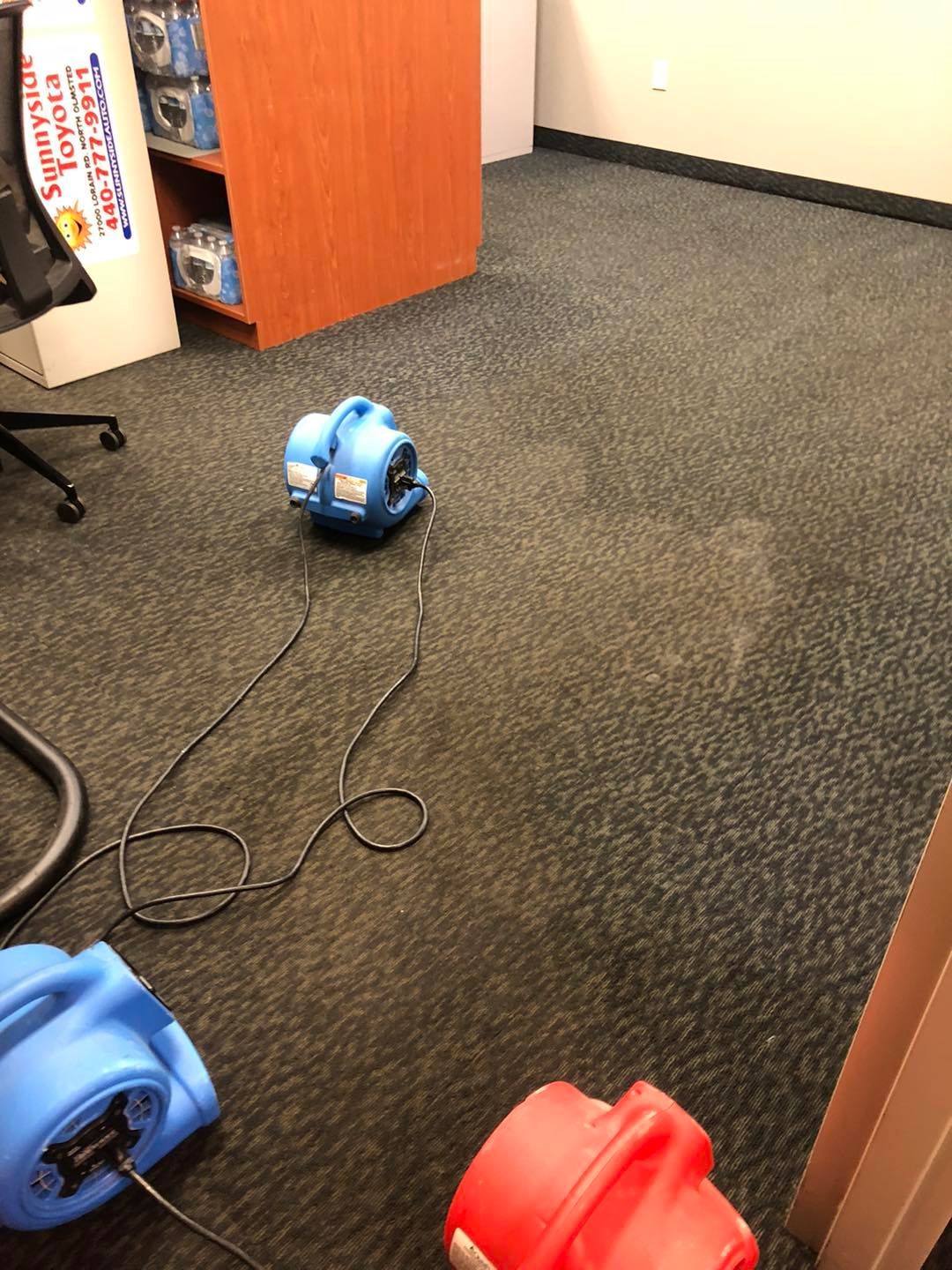 Blue and red vacuum cleaner sitting on the floor of a room in a Cleveland home.