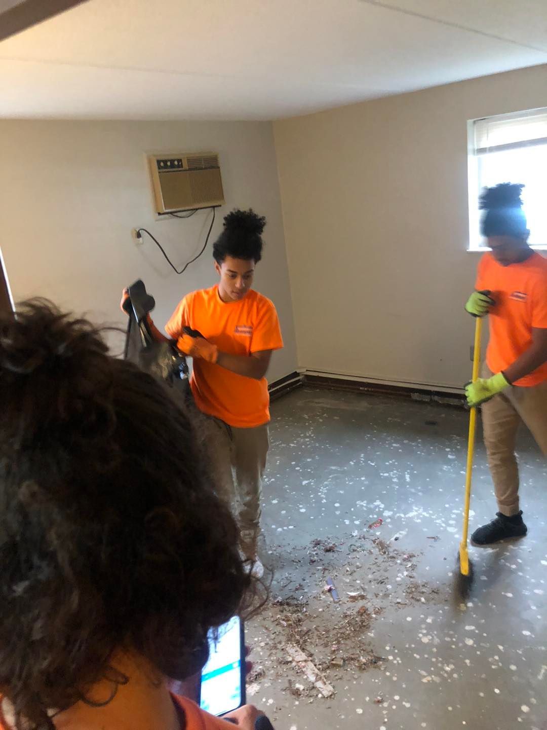 Local Cleveland cleaning crew being photographed while cleaning a room.