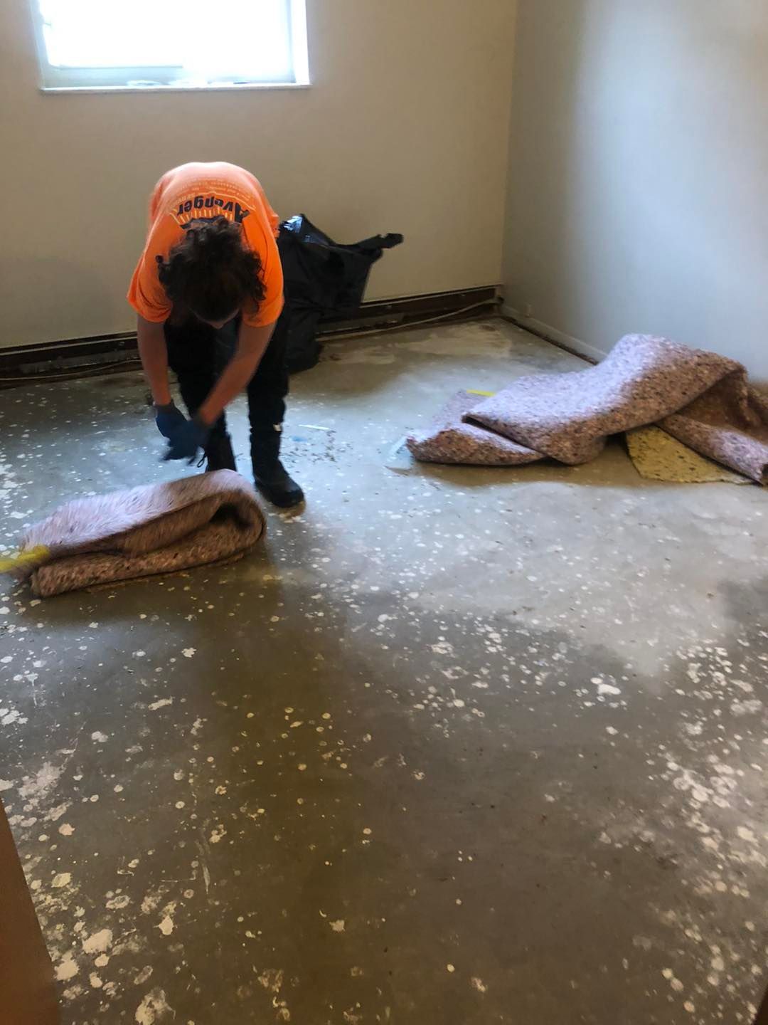 Person performing water damage restoration near me in Cleveland, OH.