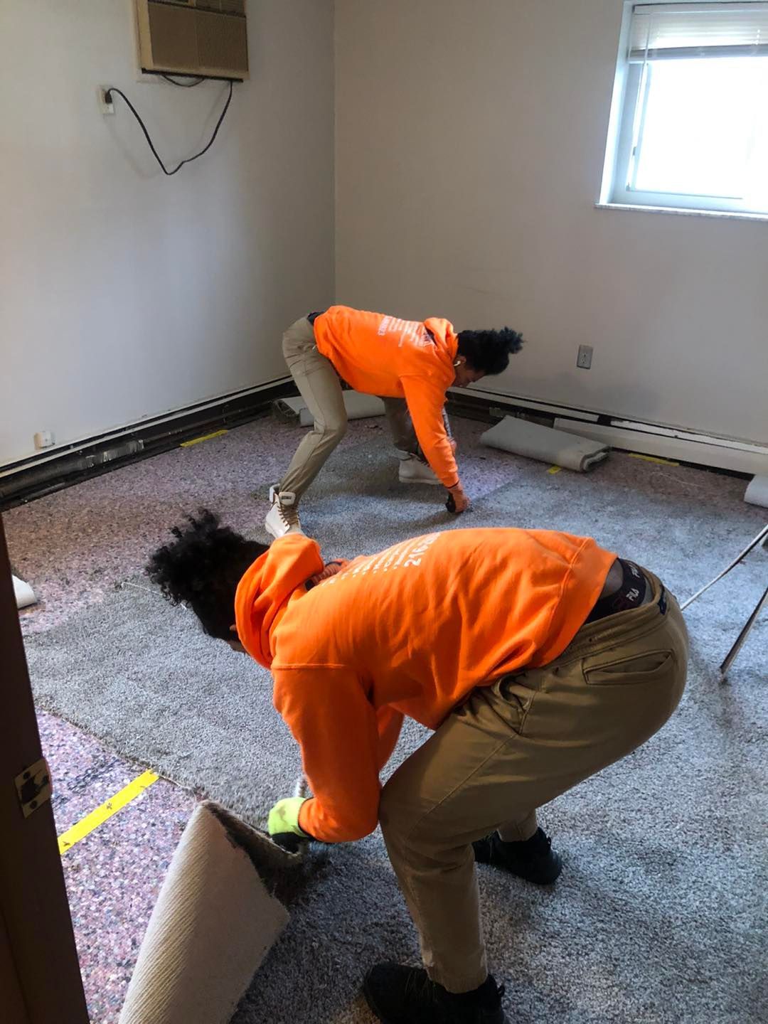 Local Cleveland carpet installers laying new carpet in a residential room.