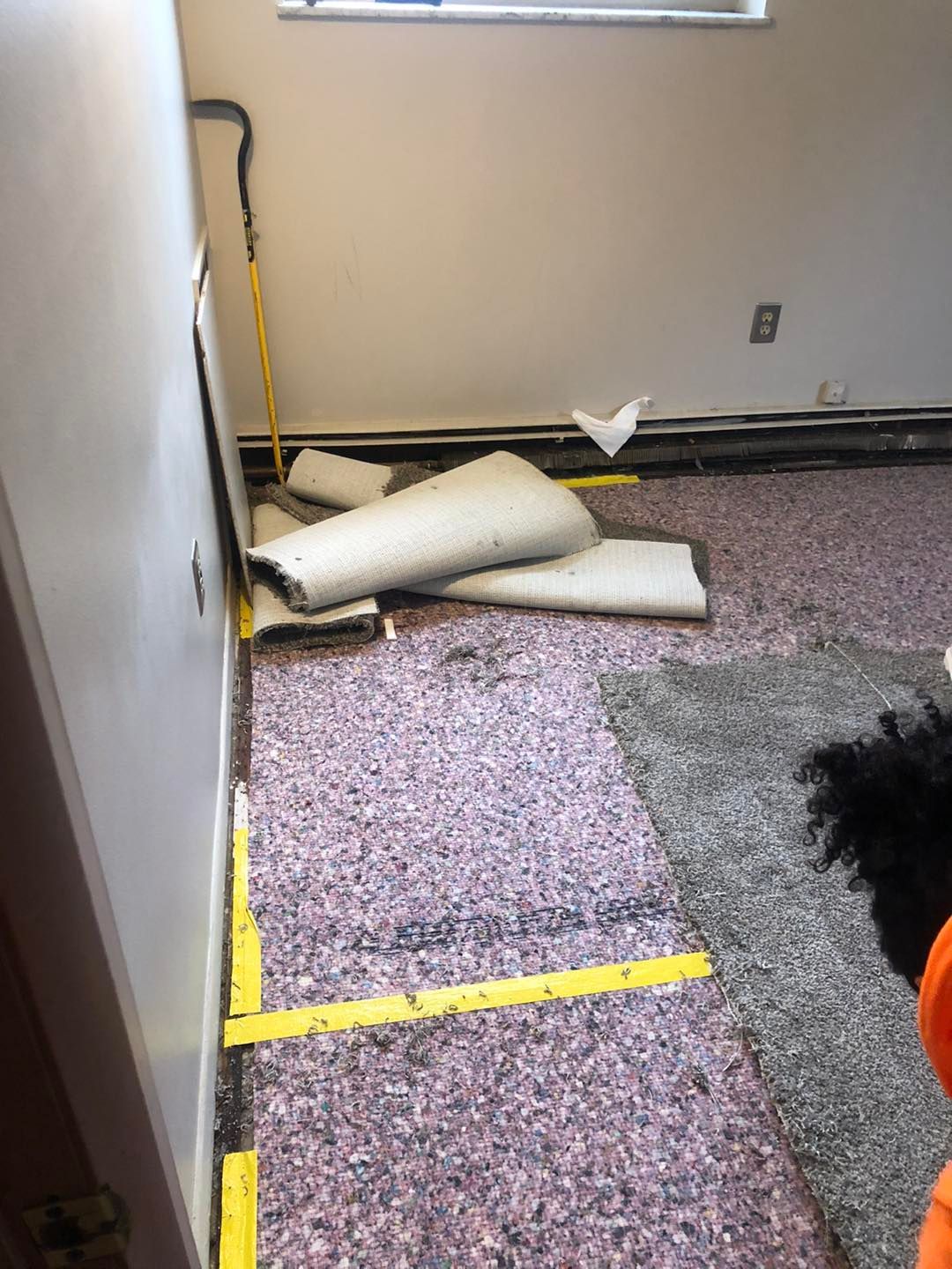 Local Cleveland carpet installer laying new carpet on the floor of a residential room.