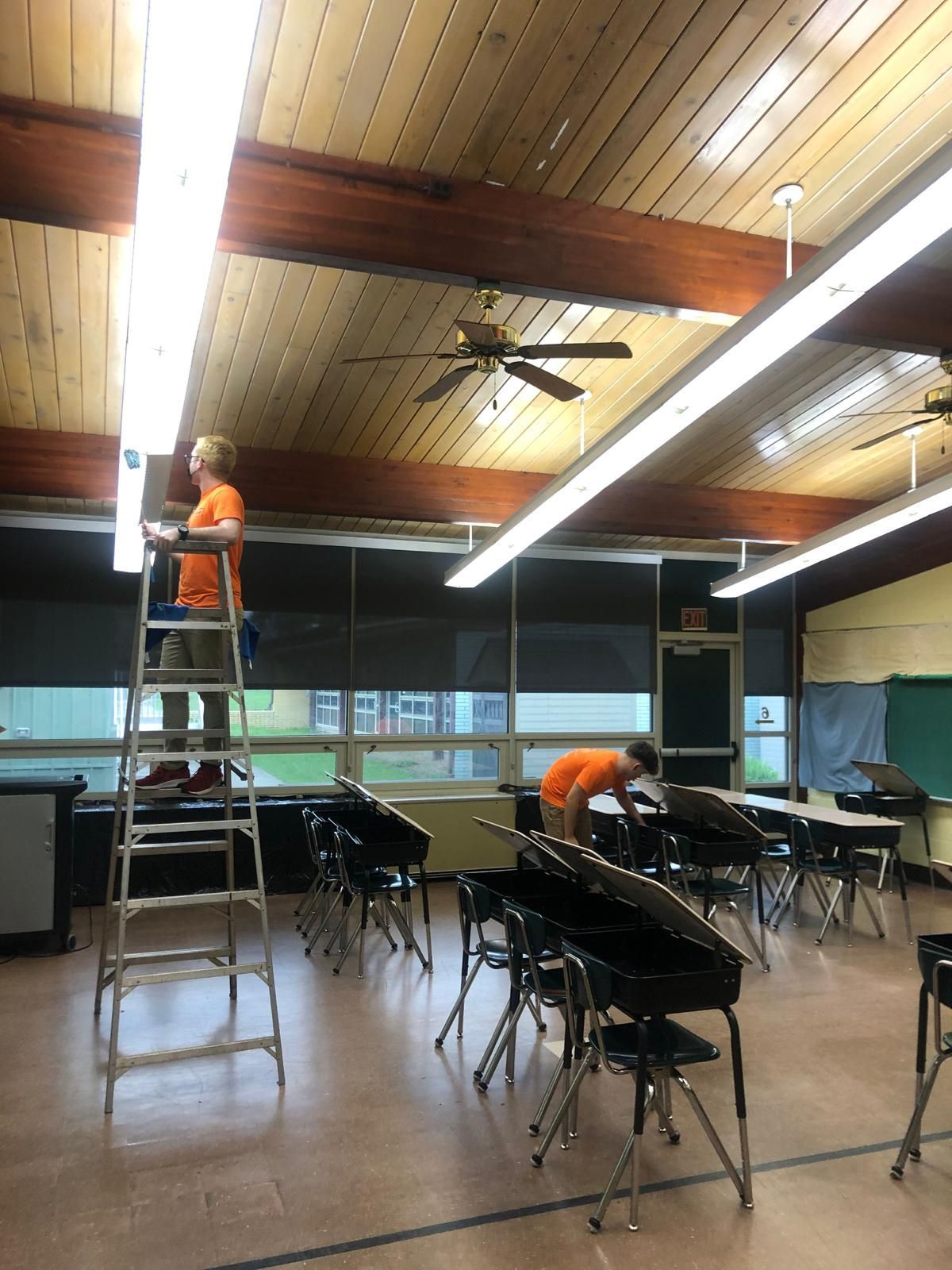 Man on a ladder in a room with an 