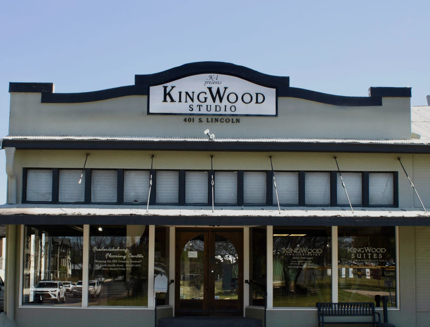 Front of Kingwood Studio storefront with awning and large windows, viewed from the street