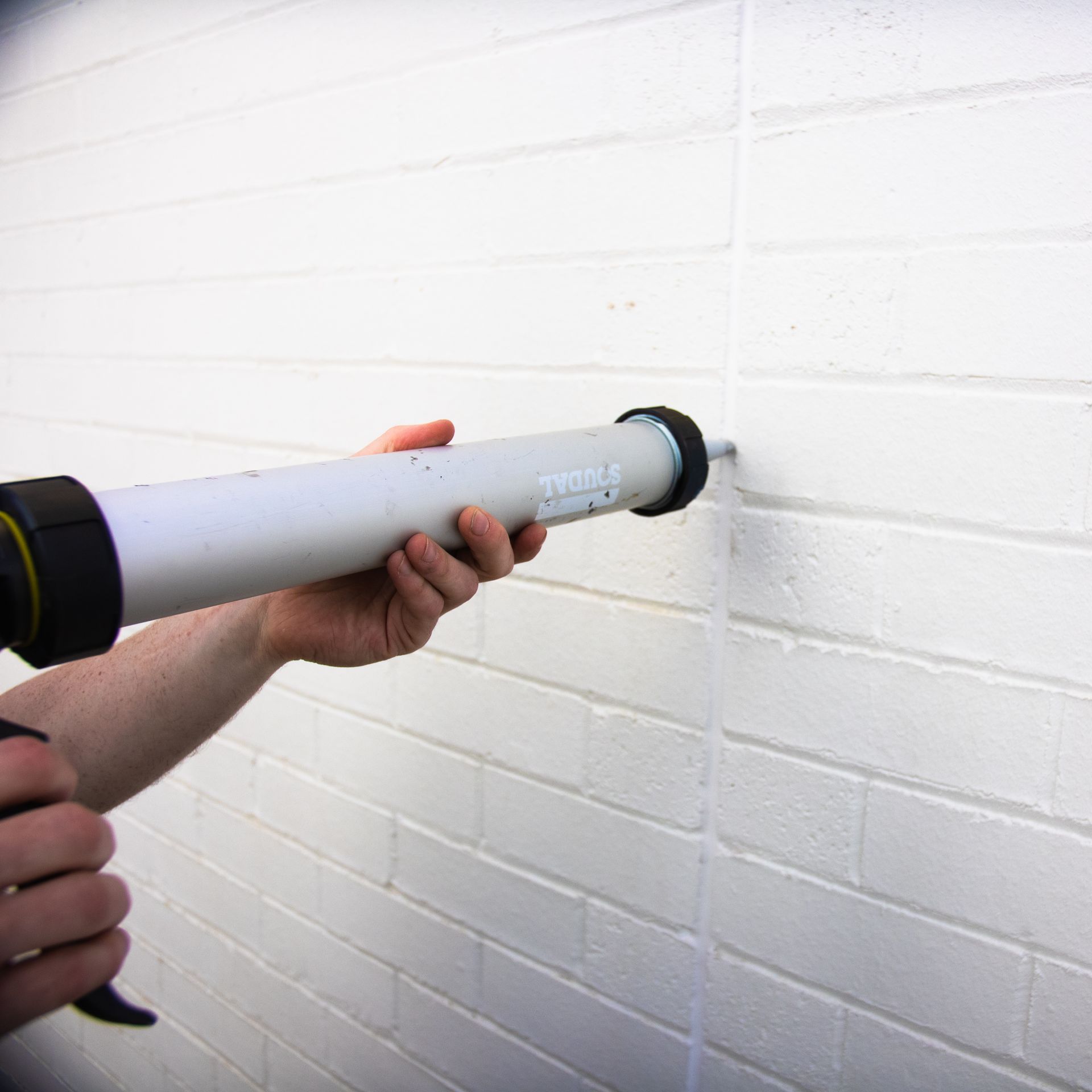 Juzzi caulking some brickwork Tony Caulks Pro Sealers Masonry Caulking