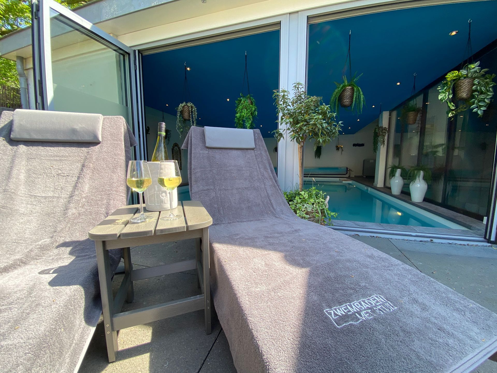 Sunbeds next to swimming pool