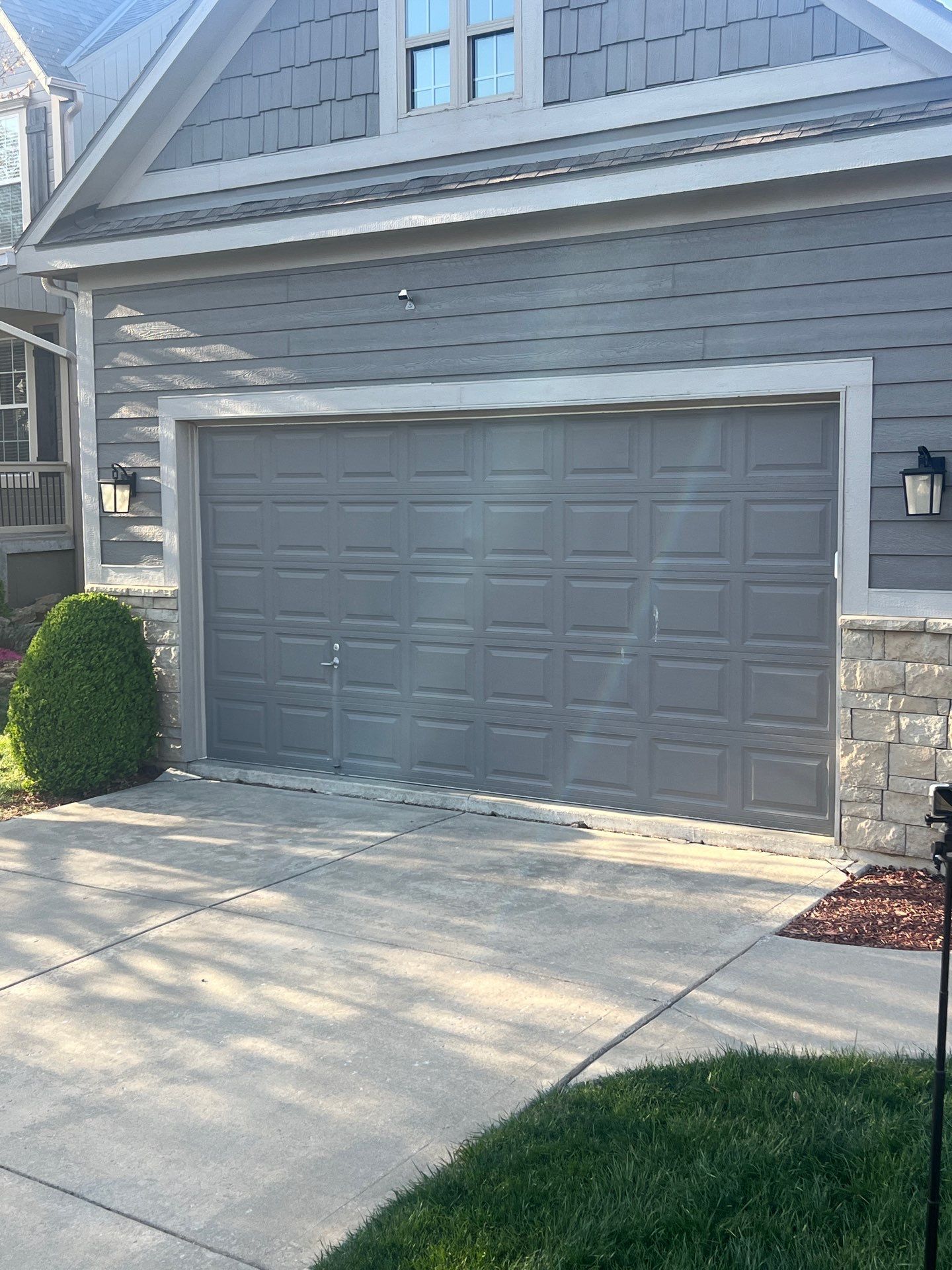A car is parked in a garage with the door open.