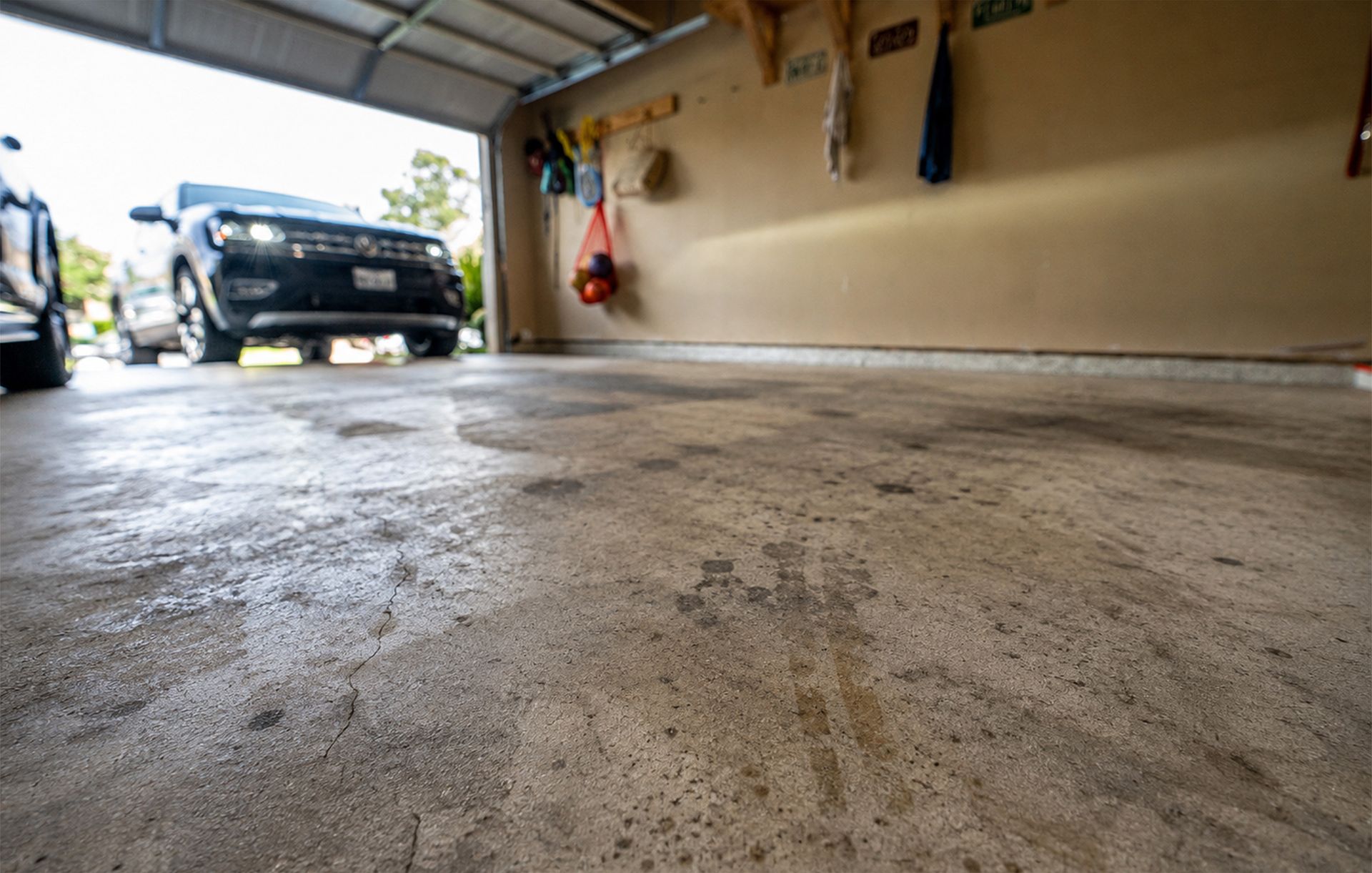 Garage with a stained and unfinished concrete floor