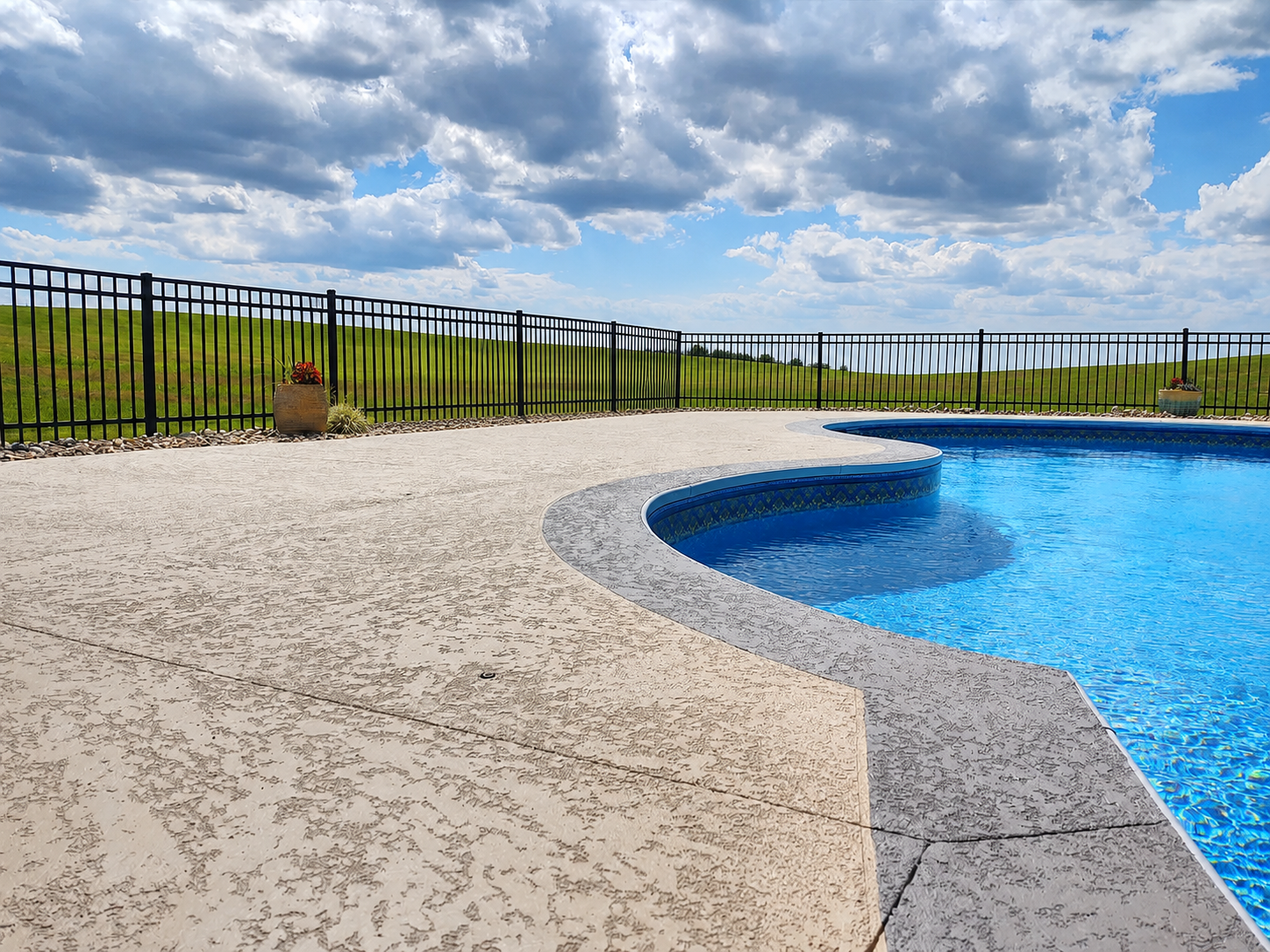Decorative resurfaced concrete surrounding a swimming pool