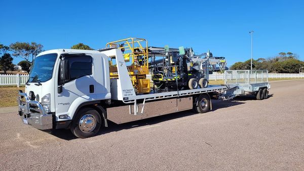 side view of a heavy equipment being transported