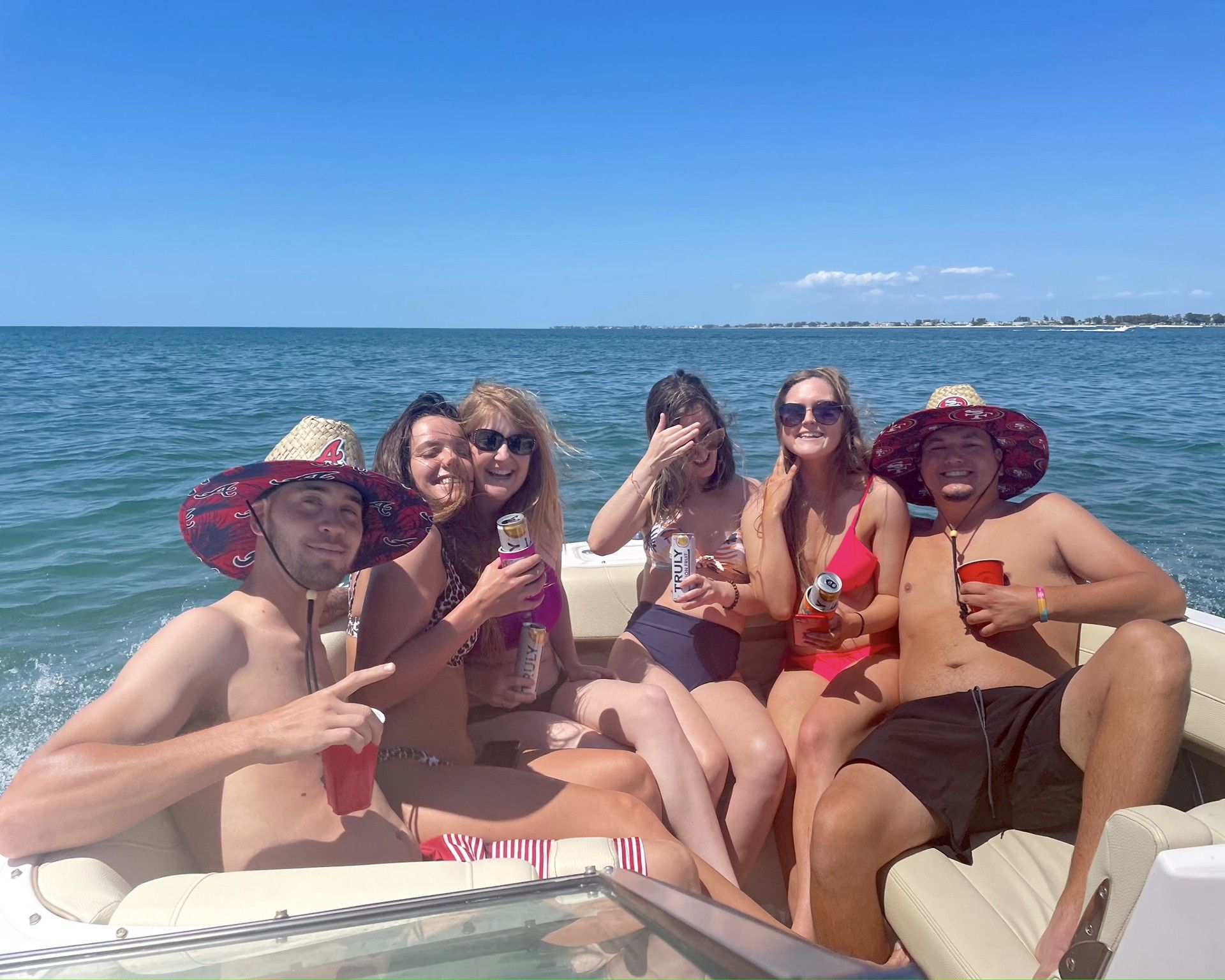A group of people are sitting on a boat in the water.