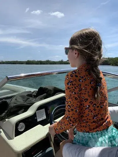 Person on a boat looking over the water on a sunny day