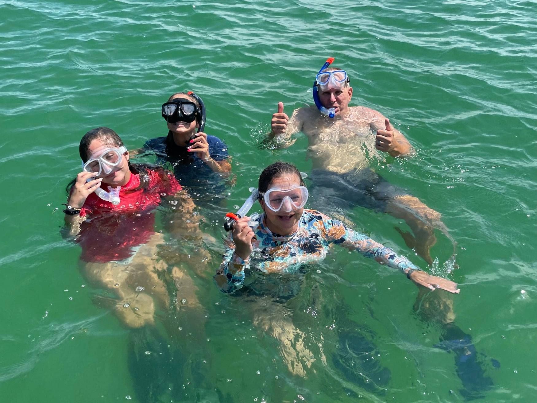 A group of people are swimming in the ocean.