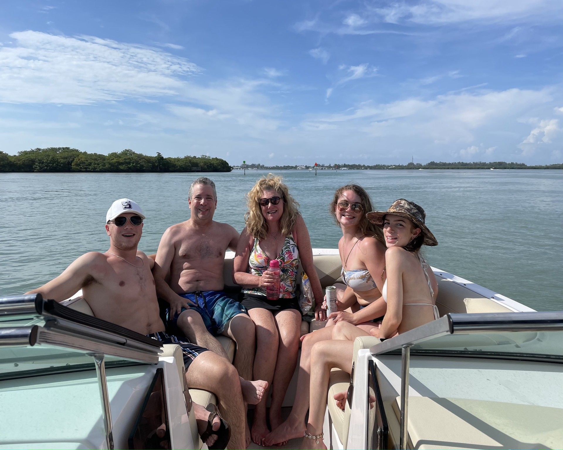 A group of people are sitting on a boat in the water.