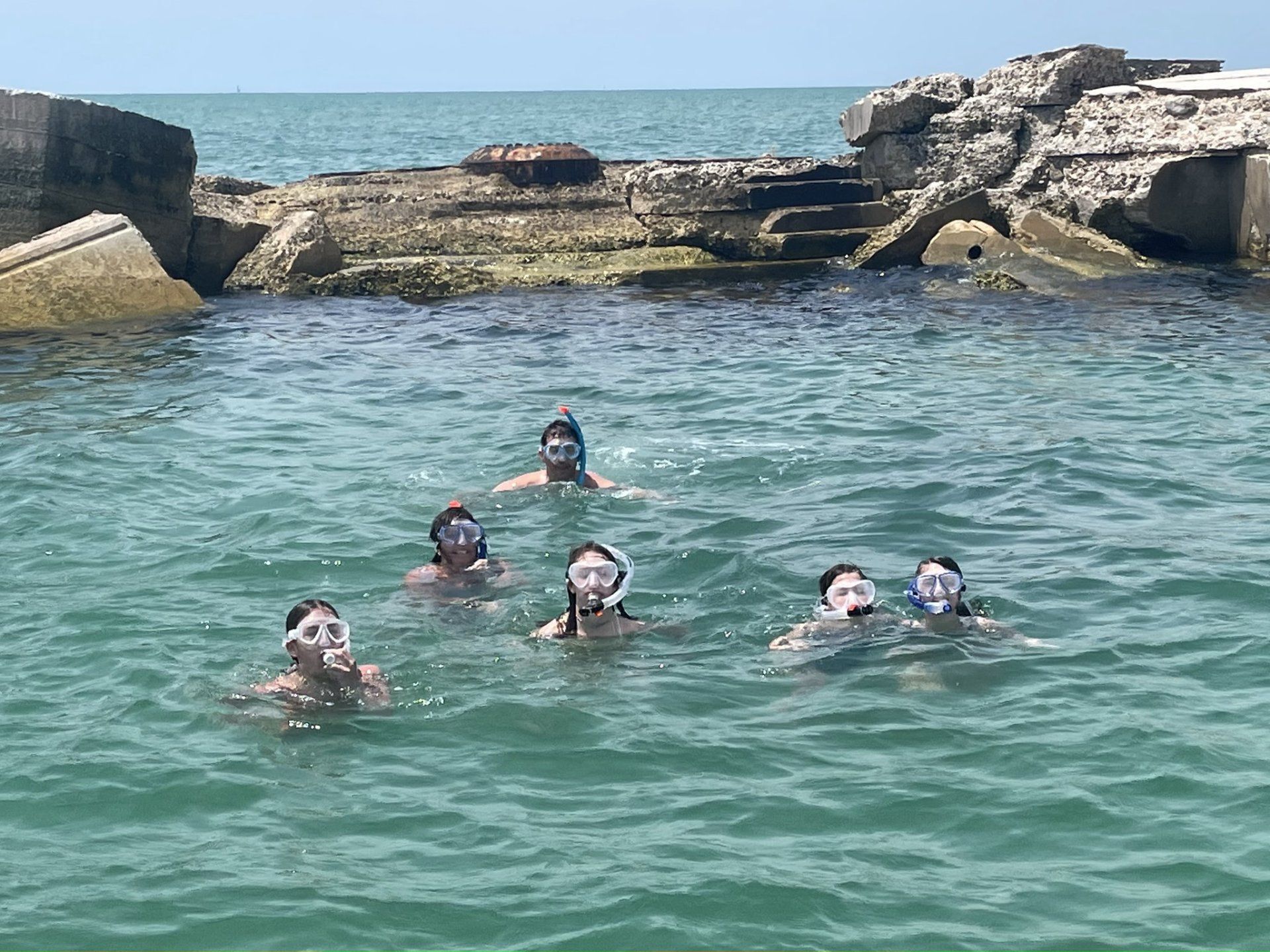 A group of people are swimming in the ocean.