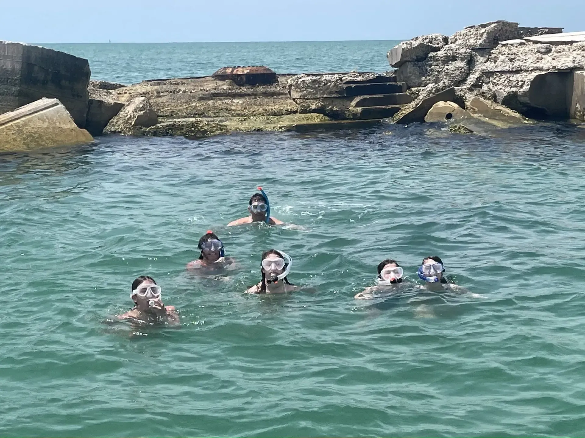 Family wearing goggles enjoying snorkeling tours