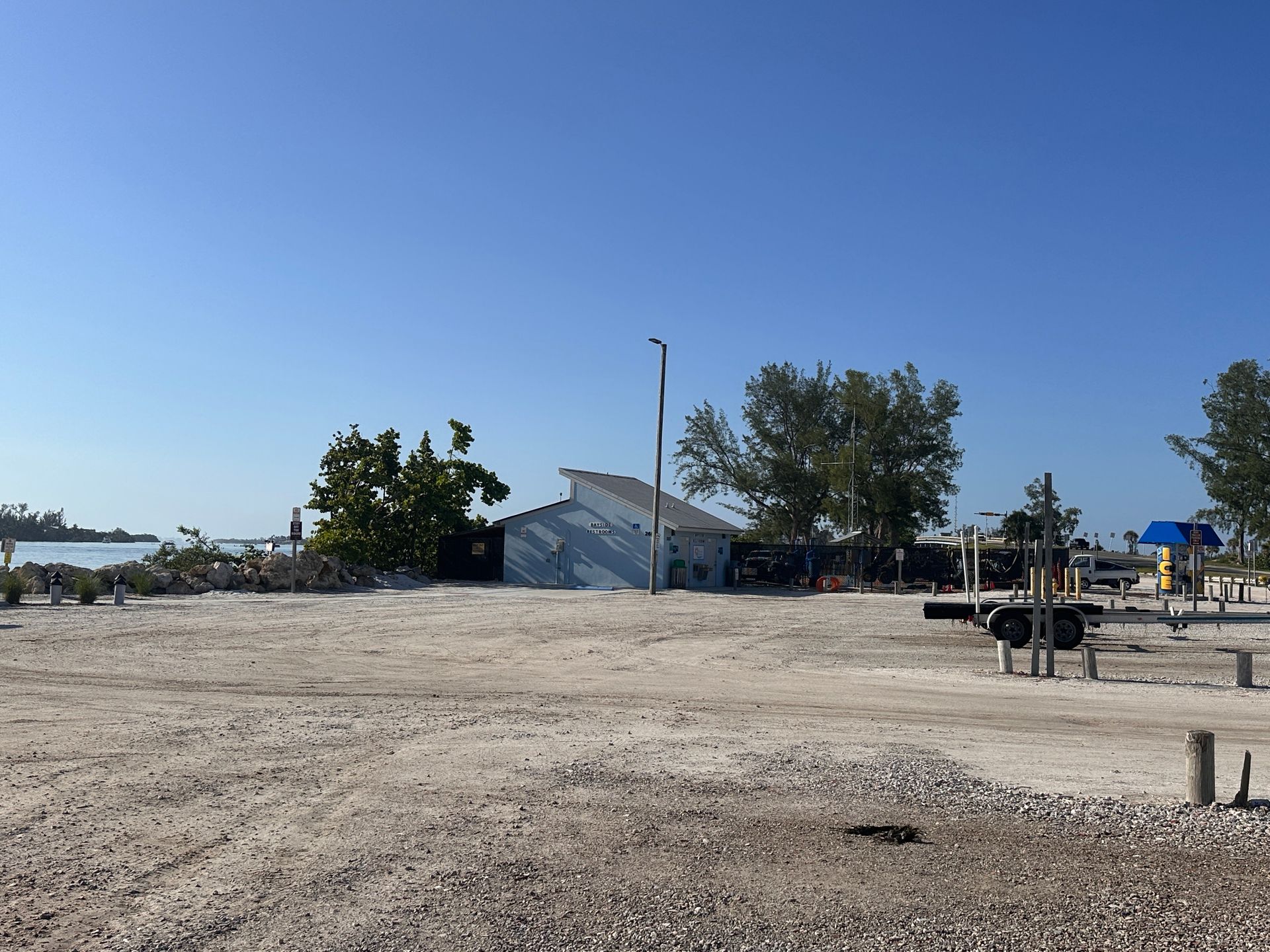 A parking lot scene showing a boat next to a dock
