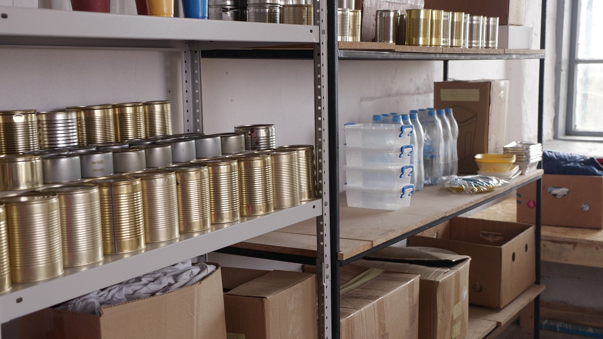 A room filled with shelves filled with cans and boxes.