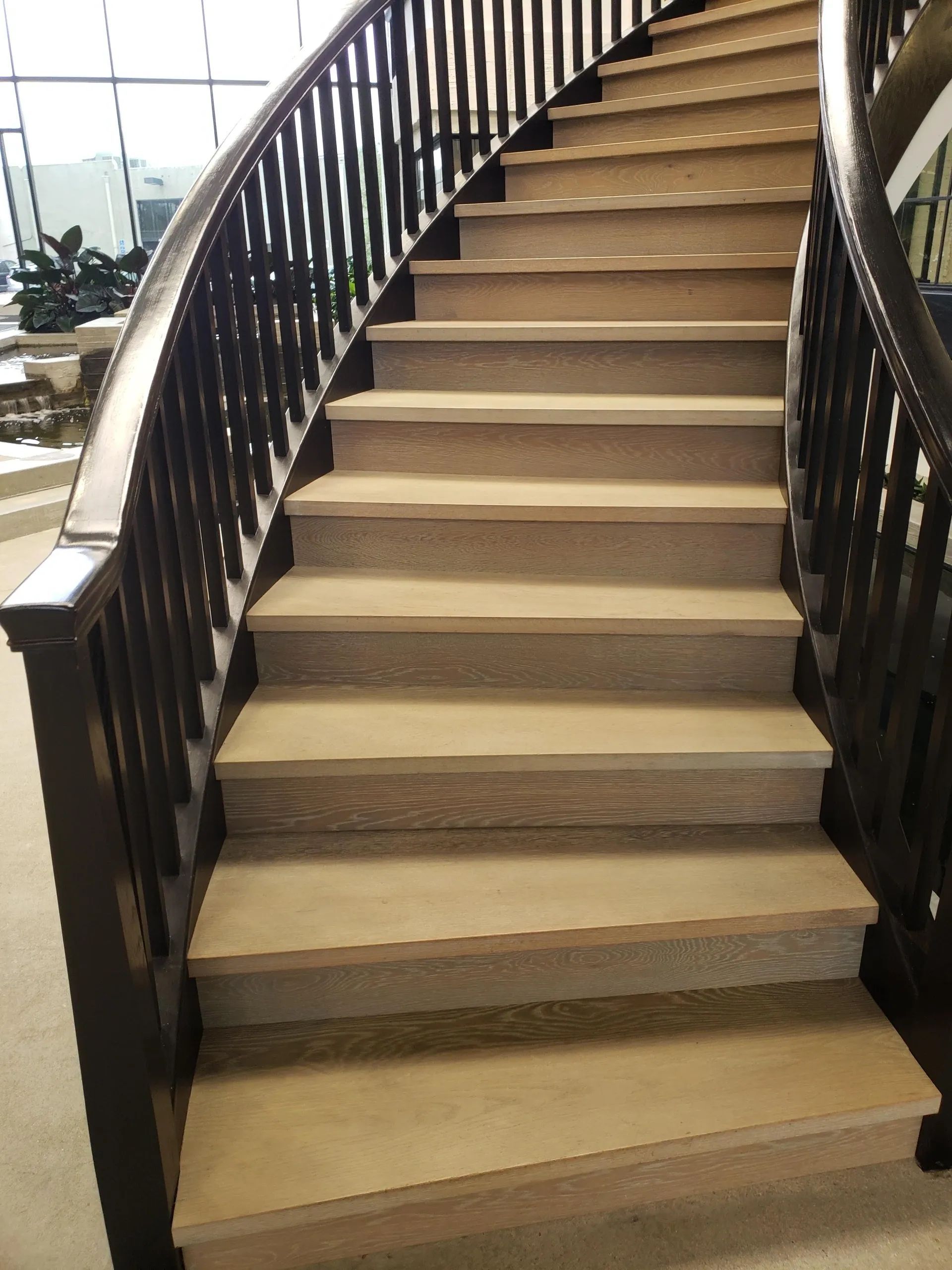 A curved staircase with a wooden railing and steps