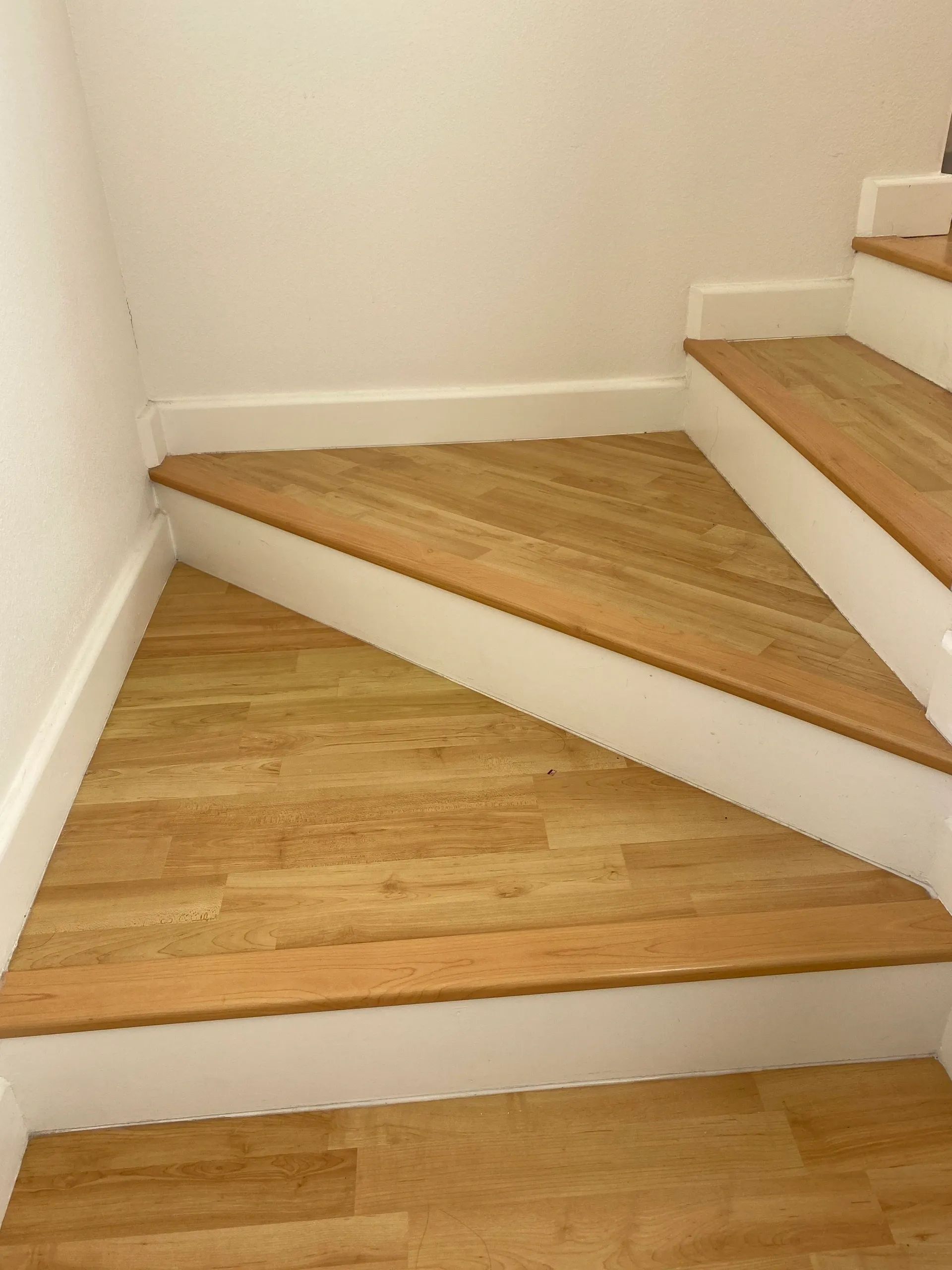 A set of stairs with wooden steps and white trim