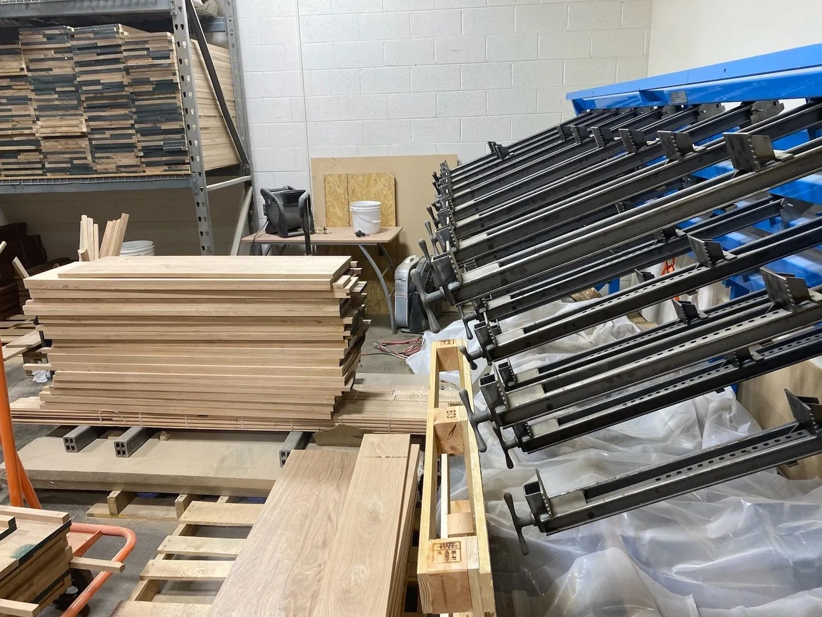A warehouse filled with lots of wooden boards and pallets
