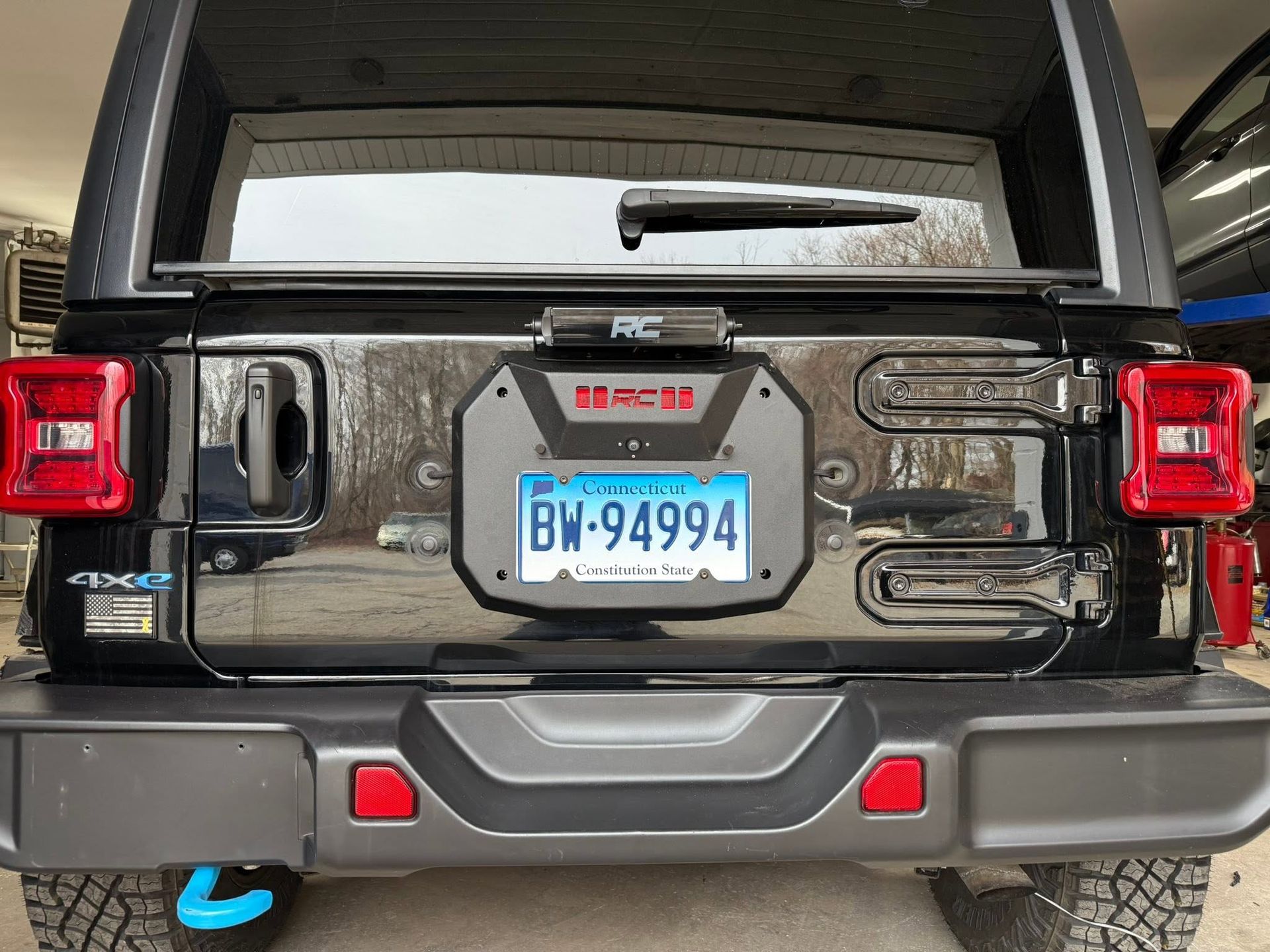 Rear view of a black SUV with a Pennsylvania license plate and covered cargo area.