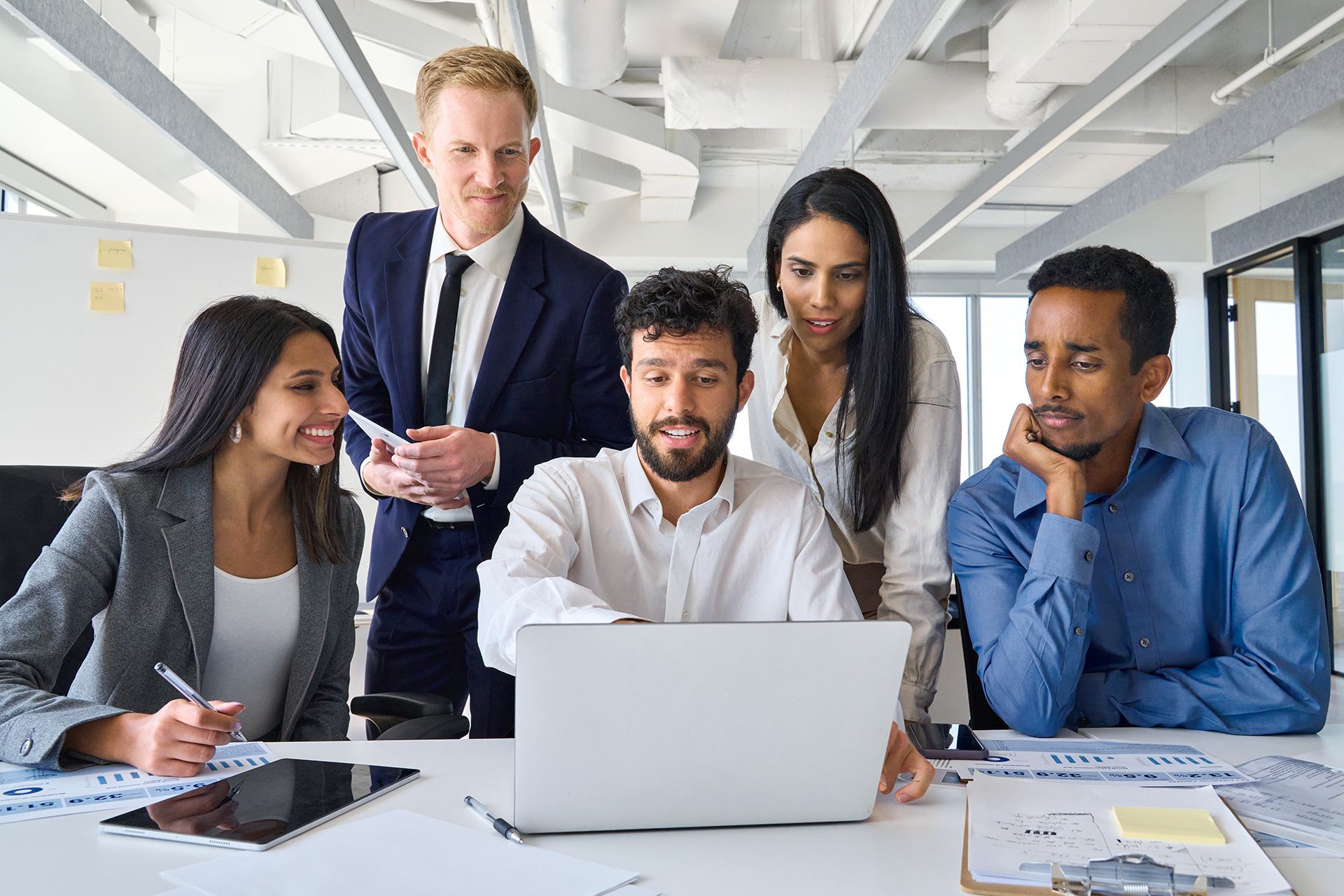 A group of people are looking at a laptop computer.