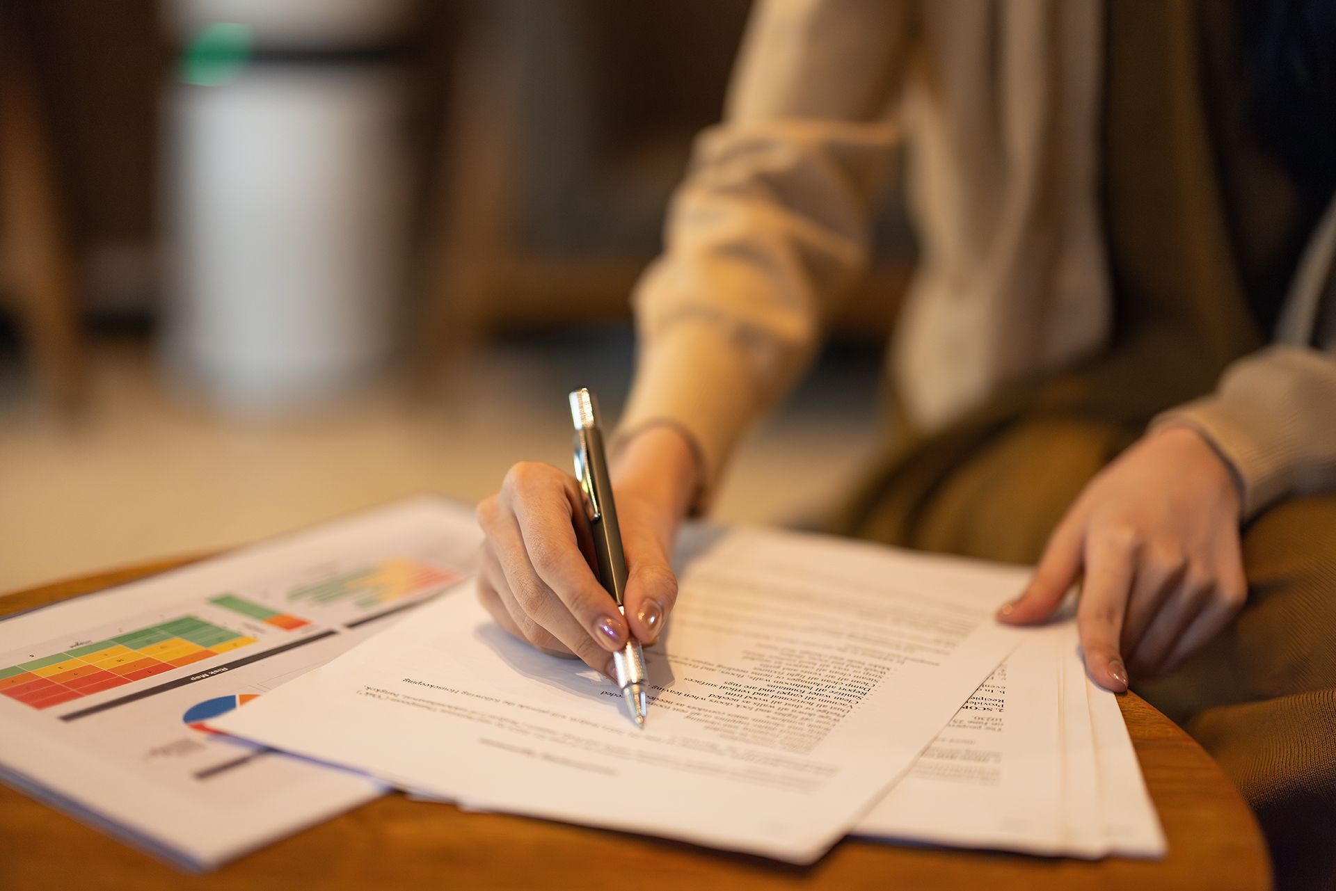 A person is writing on a piece of paper with a pen.