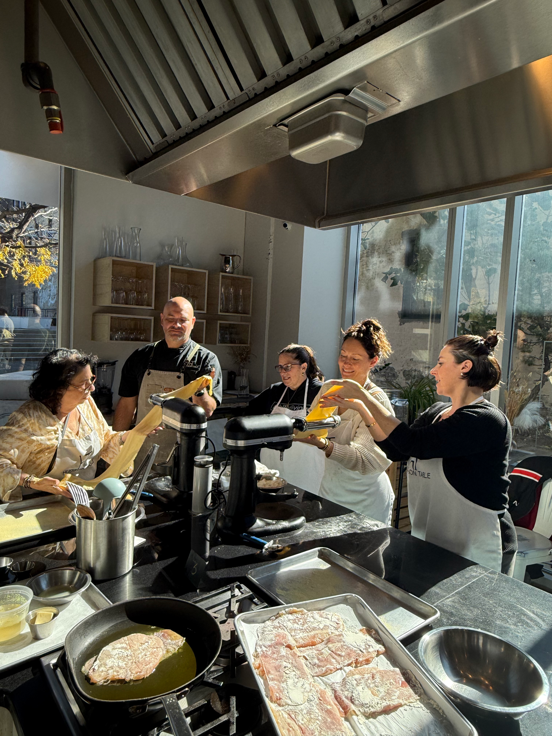 A group of people are cooking food in a kitchen.