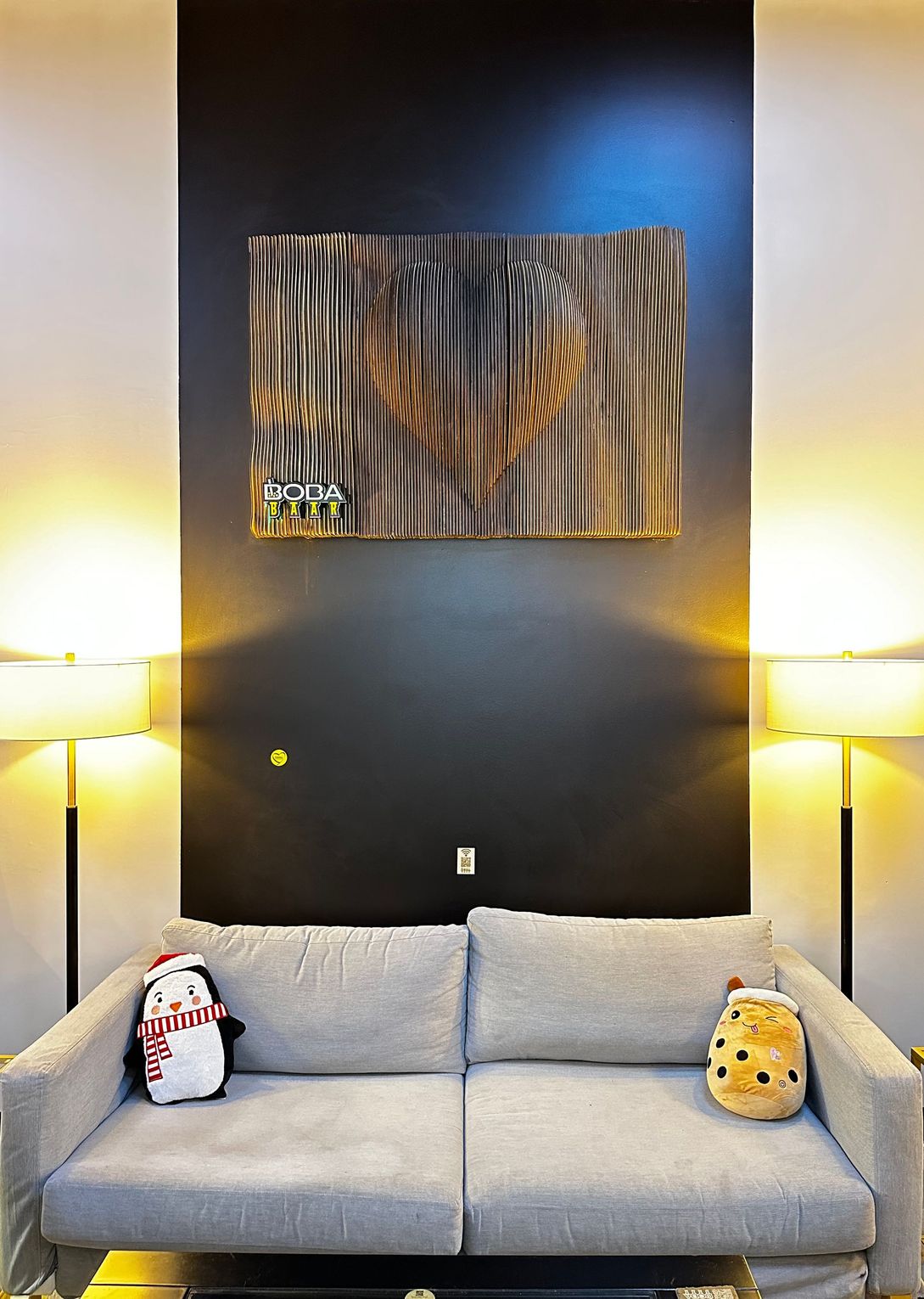 A living room with a couch and a painting on the wall