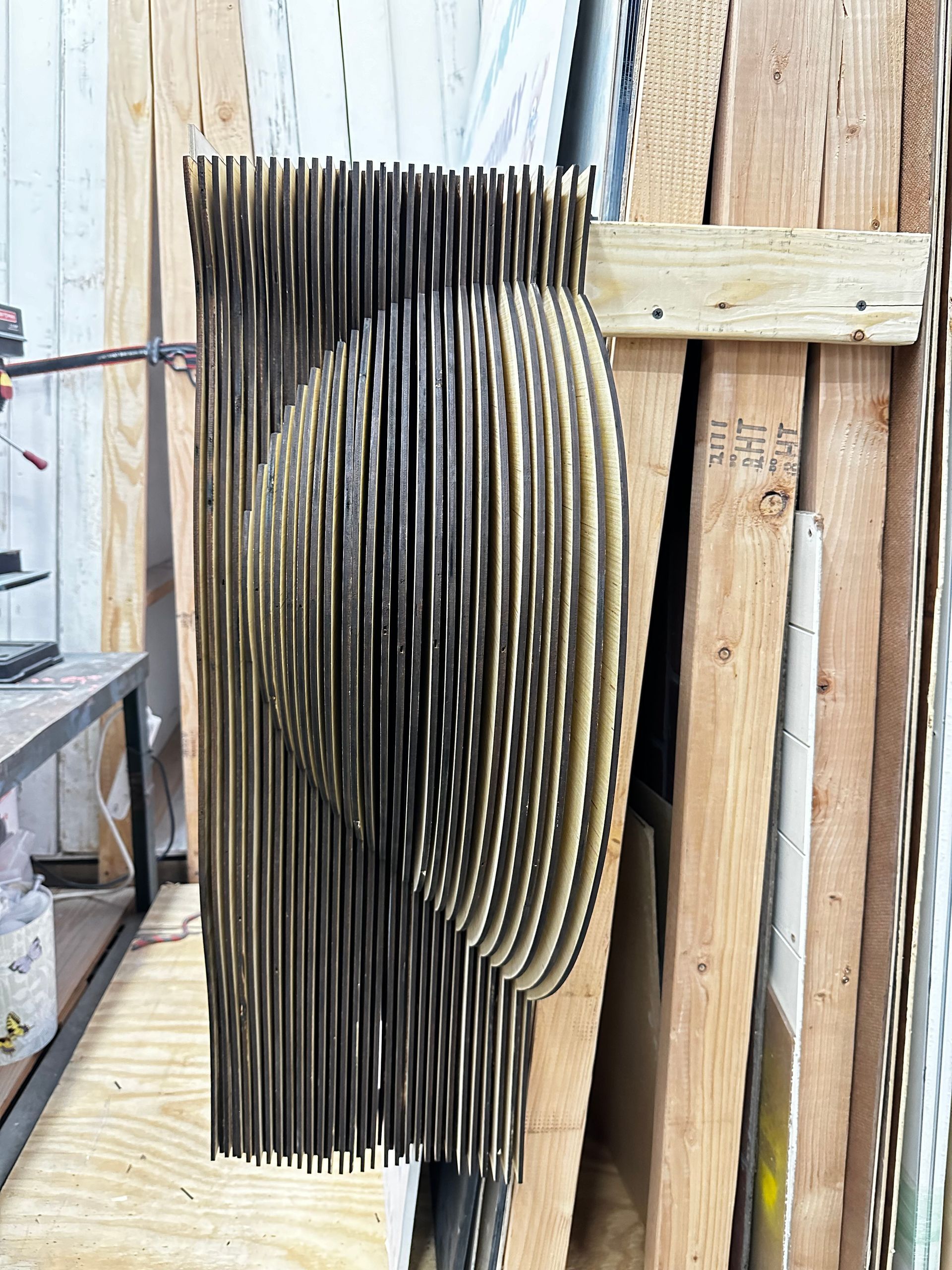 A wooden sculpture is sitting on top of a wooden crate.