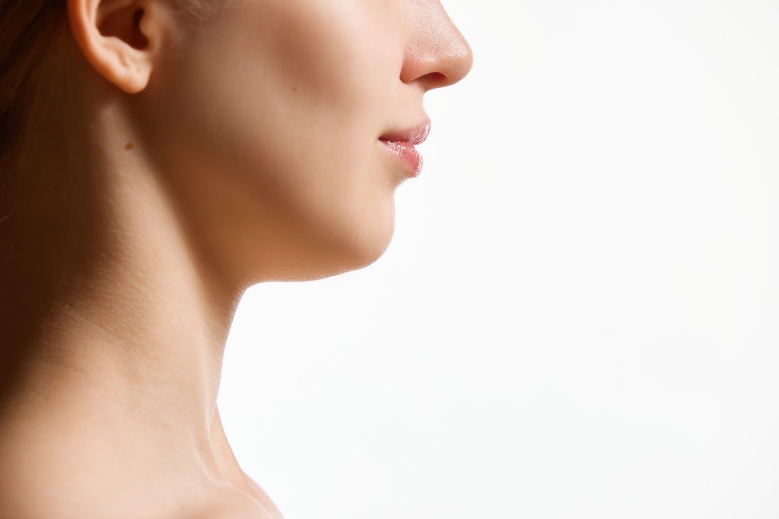 Side profile of a person’s neck and jawline against a plain white background