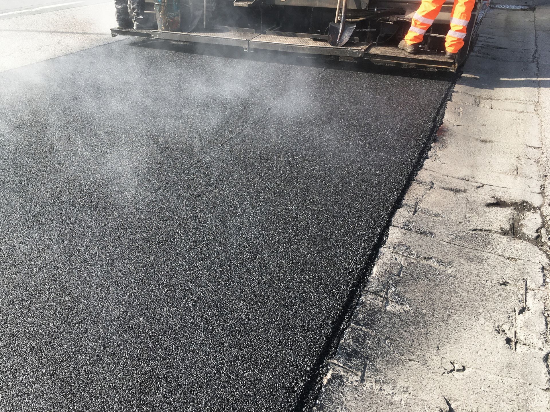 Road resurfacing showcasing high-quality lasik asphalt paving in progress for smooth streets Road resurfacing showcasing high-quality lasik asphalt paving in progress for smooth streets