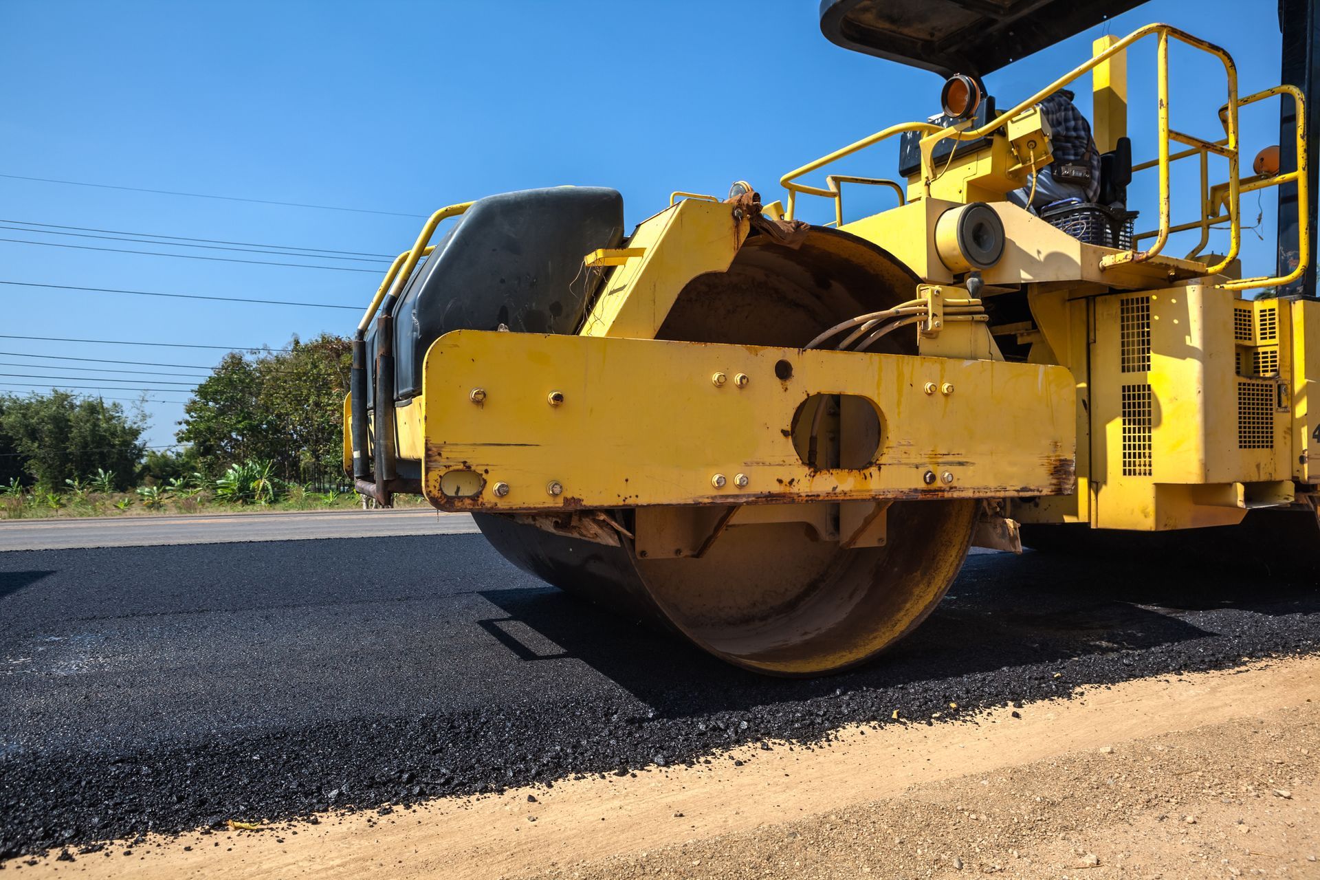 Asphalt paving with an asphalt roller to ensure a smooth and durable surface