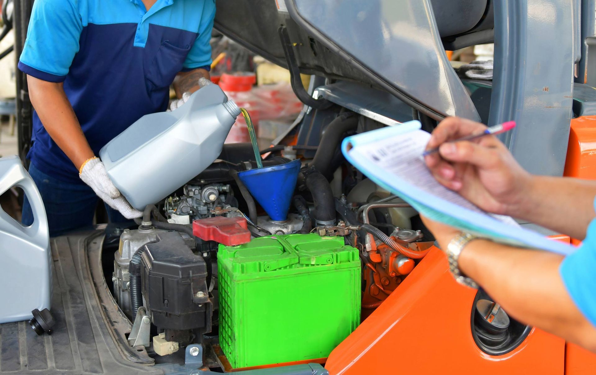 Pouring quality oil into the engine motor | Derrimut, VIC | Discount Forklifts