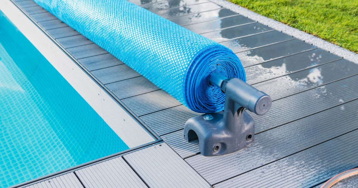 a blue pool cover with white edges, protecting the water from debris and keeping it clean and safe.