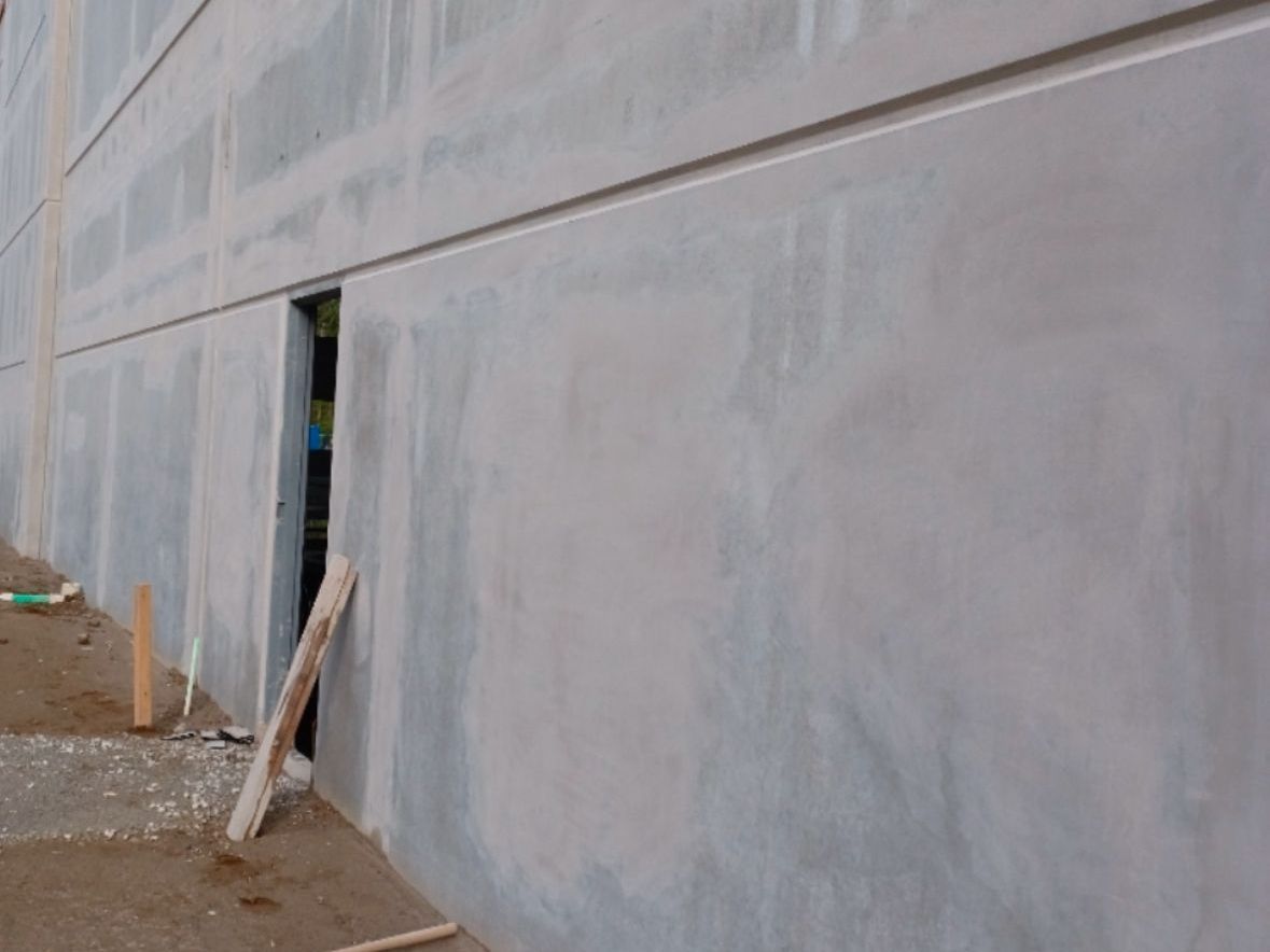 A concrete wall with a hole in the middle of it