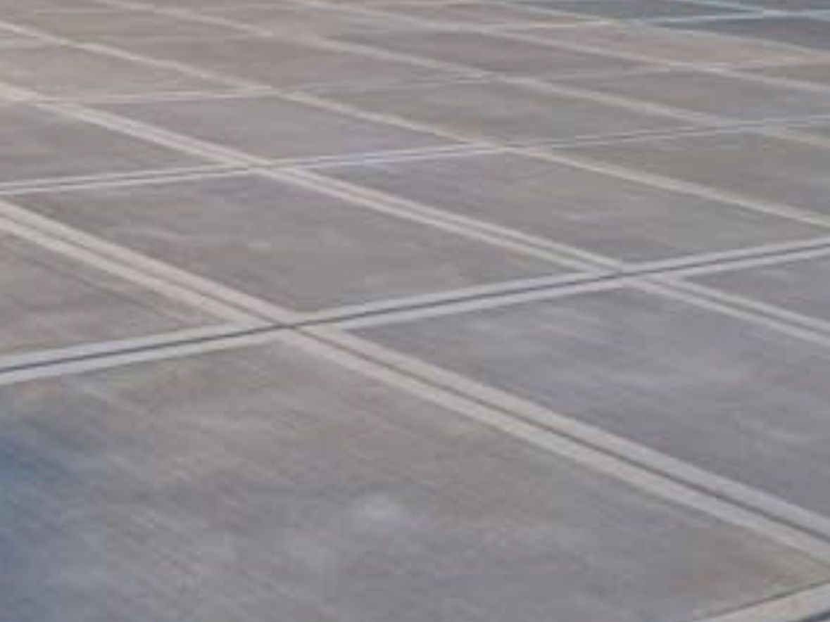 A close up of a concrete floor with a lot of squares on it.