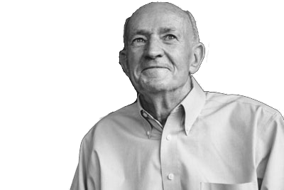 Smiling man in a light button-up shirt against a white background