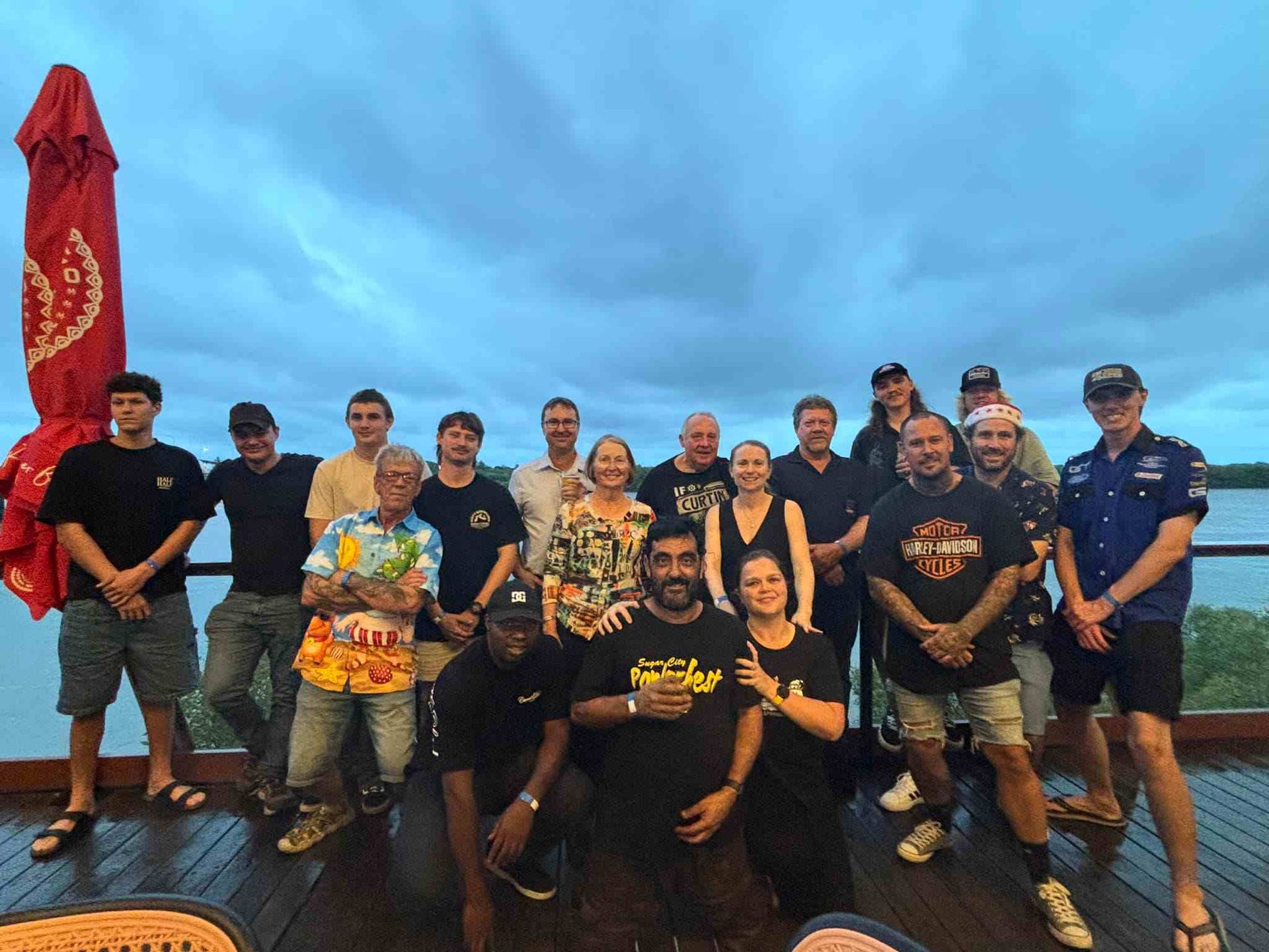 A Group of People Posing for a Picture on a Deck — Curtin Engine Reconditioning Pty Ltd In Paget, QLD