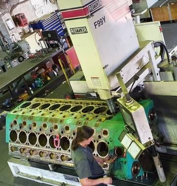 A person is working on a cylinder block  — Curtin Engine Reconditioning Pty Ltd In Paget, QLD