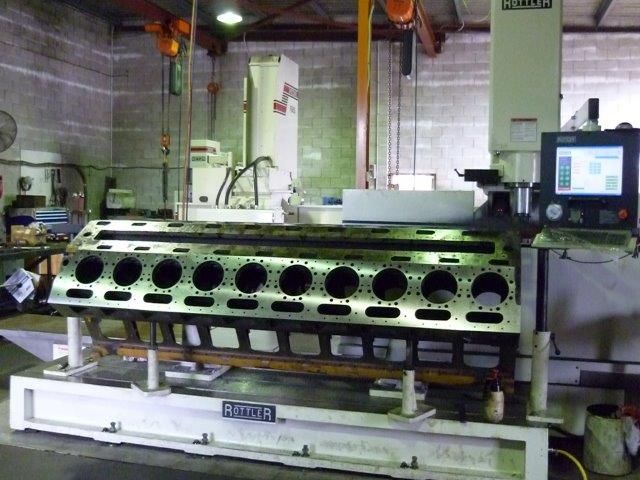Large engine block being machined in a workshop — Curtin Engine Reconditioning Pty Ltd In Paget, QLD