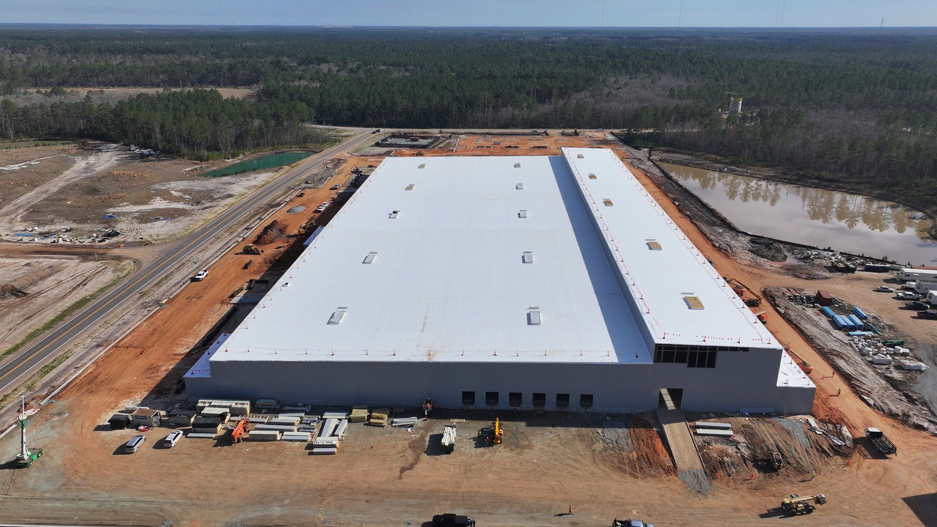 An aerial view of a large white building under construction