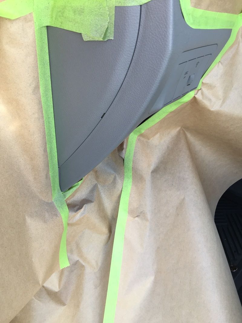 Masked gray car panel with green painter’s tape and brown paper masking for paint prep