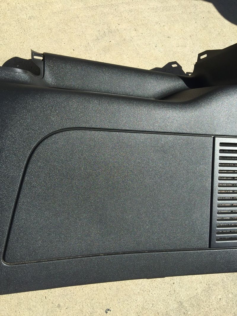 Black textured device casing with a rectangular panel and vented grille on the right