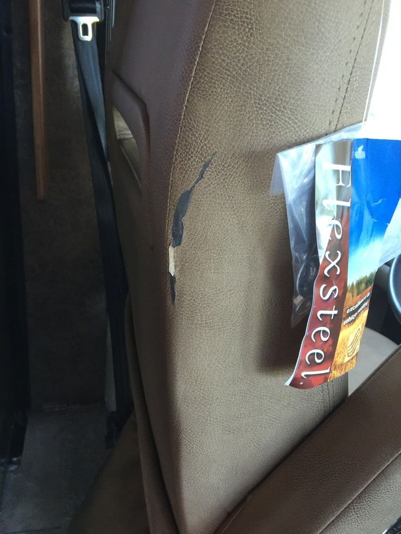 Beige car seat with a Steel candy wrapper tucked against the side panel